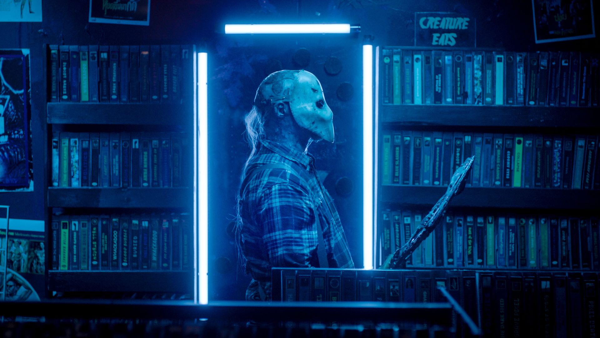 Image of a man in mask haunting a video store.