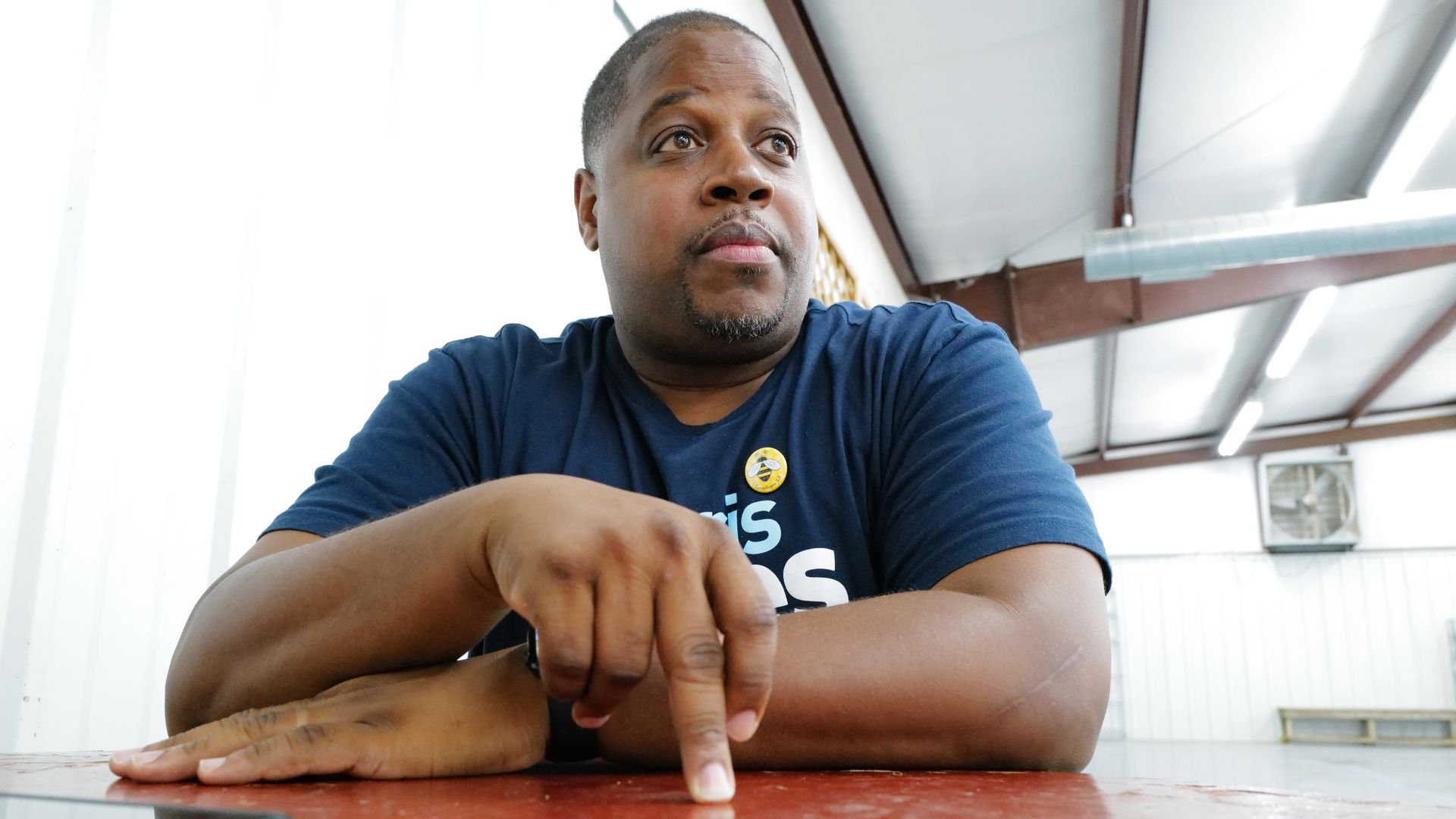 A photo of Arkansas gubernatorial candidate Chris Jones sitting at a table, making a point with his hand. 