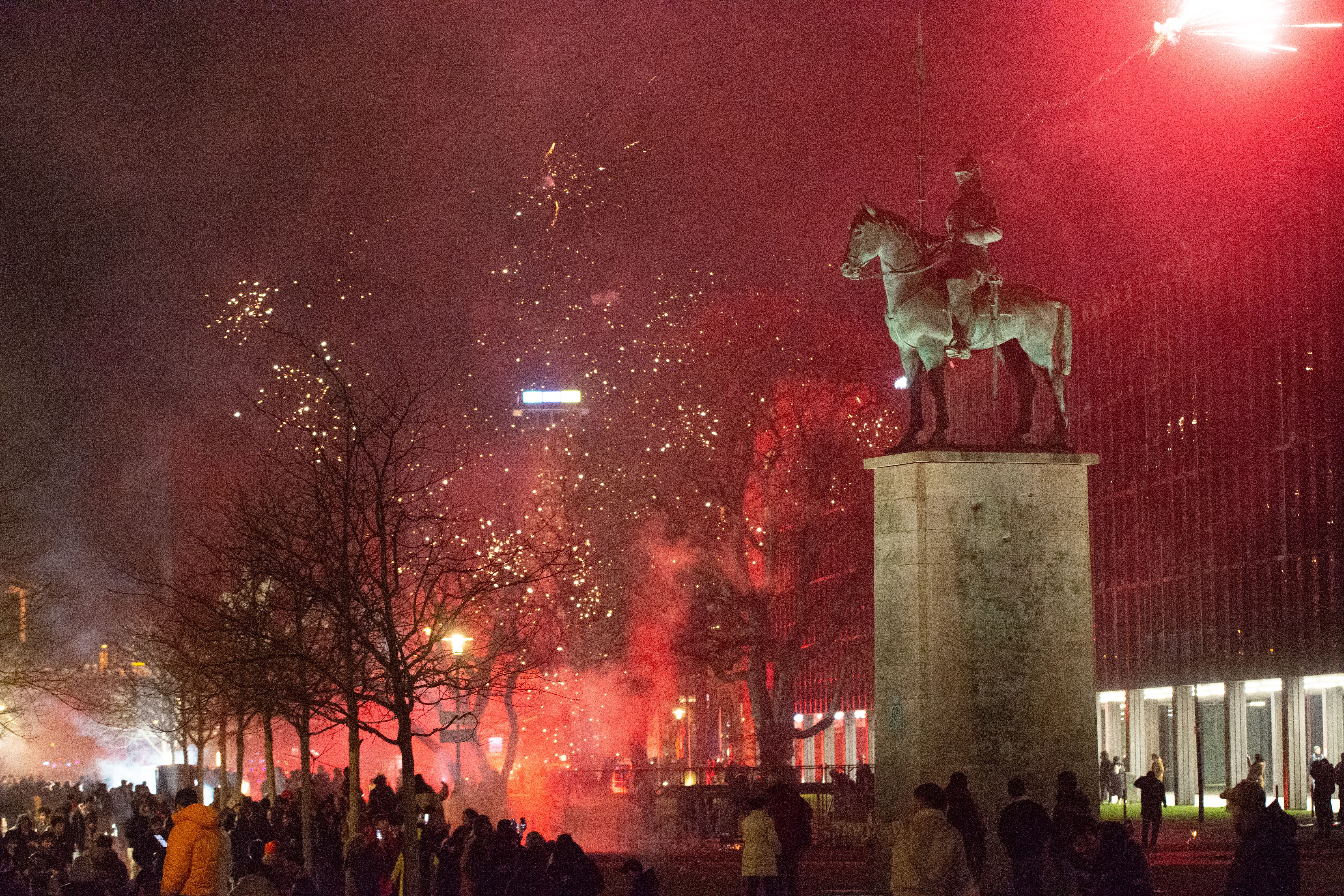 People celebrate with fireworks along the Rhine River during the upcoming New Year's Eve celebration in Cologne, Germany, on December 31, 2024. 
