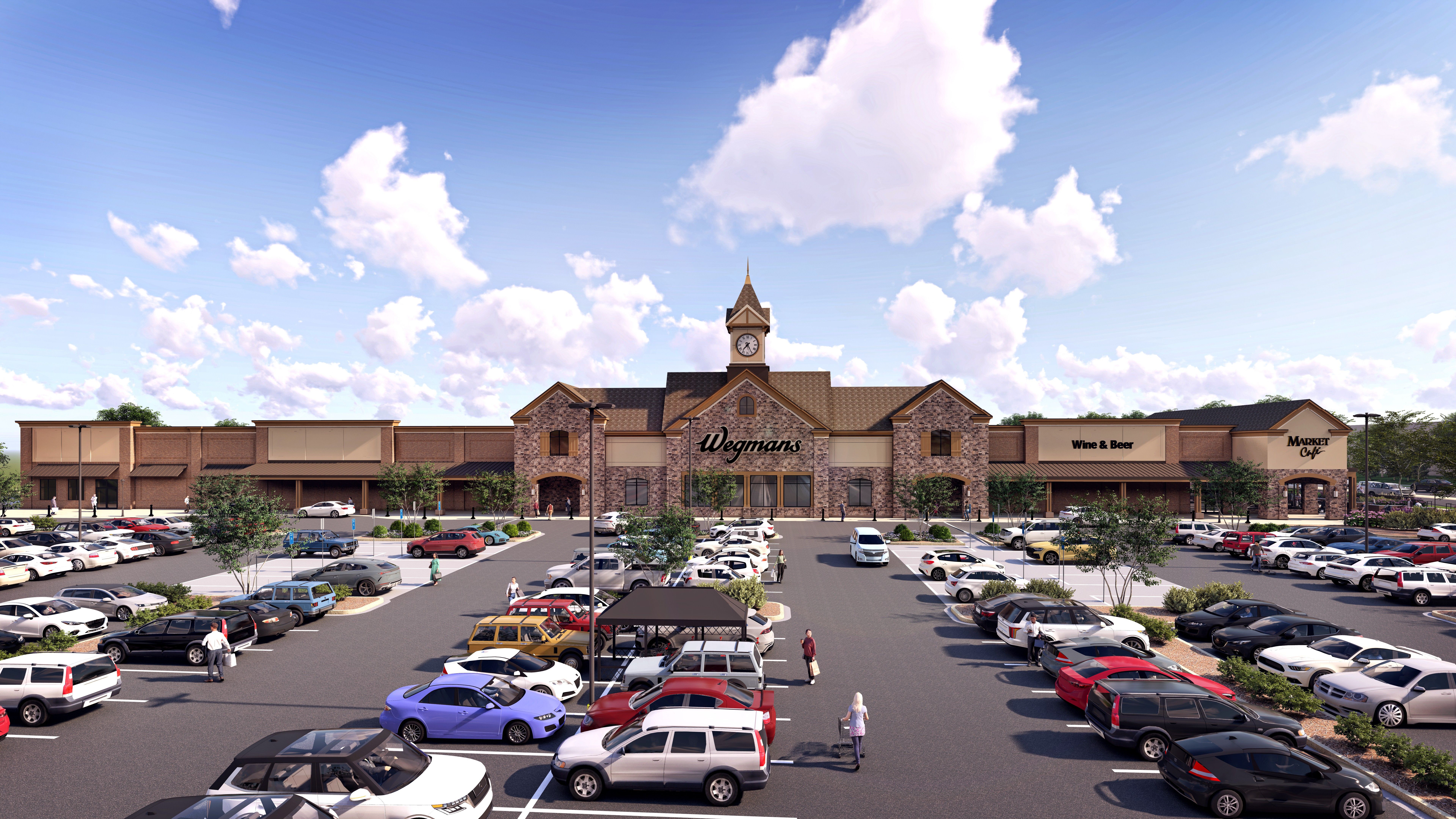 Parking lot full of cars in front of a large Wegmans store with a clock tower, wine and beer section, and Market Cafe under a blue sky with white clouds.