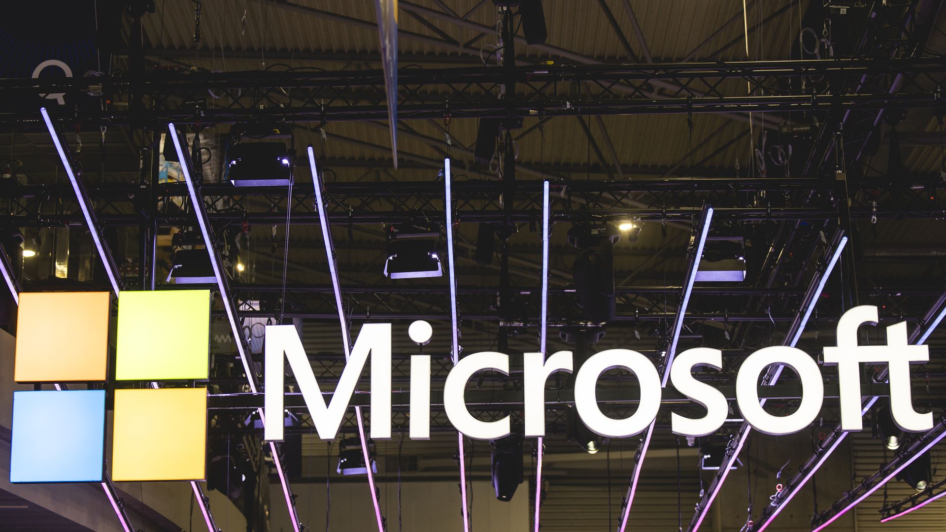 A logo sits illuminated at the Microsoft booth in the Mobile World Congress 2024.