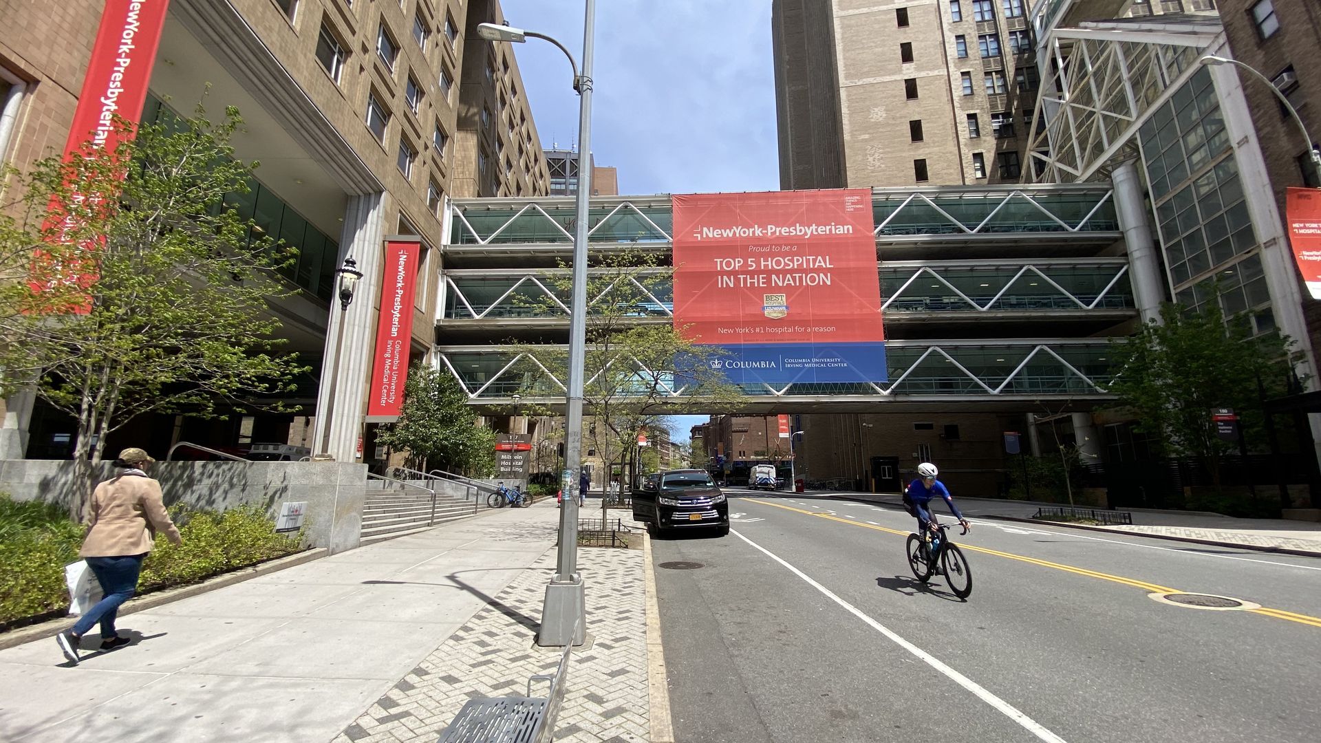 An empty street near a brown NewYork-Presbyterian hospital complex.