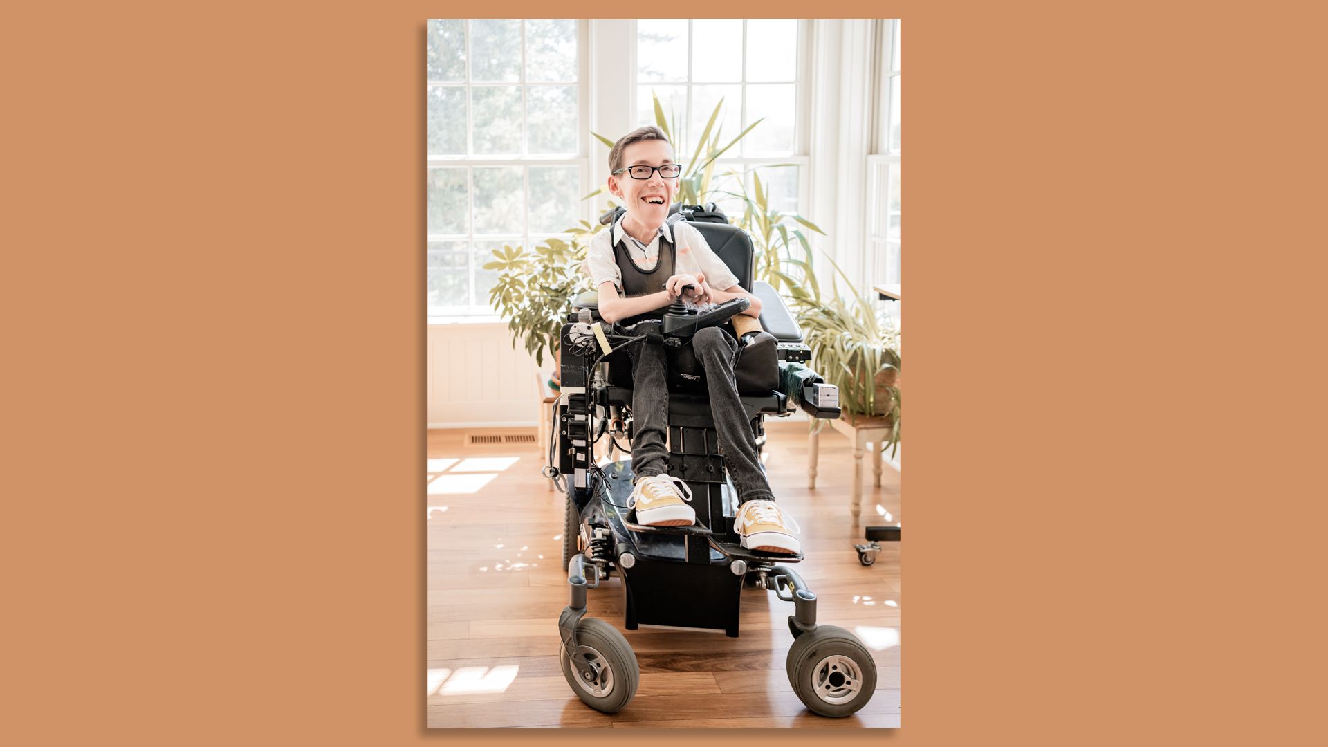 Shane Burcaw, a wheelchair user, in a sunny room.