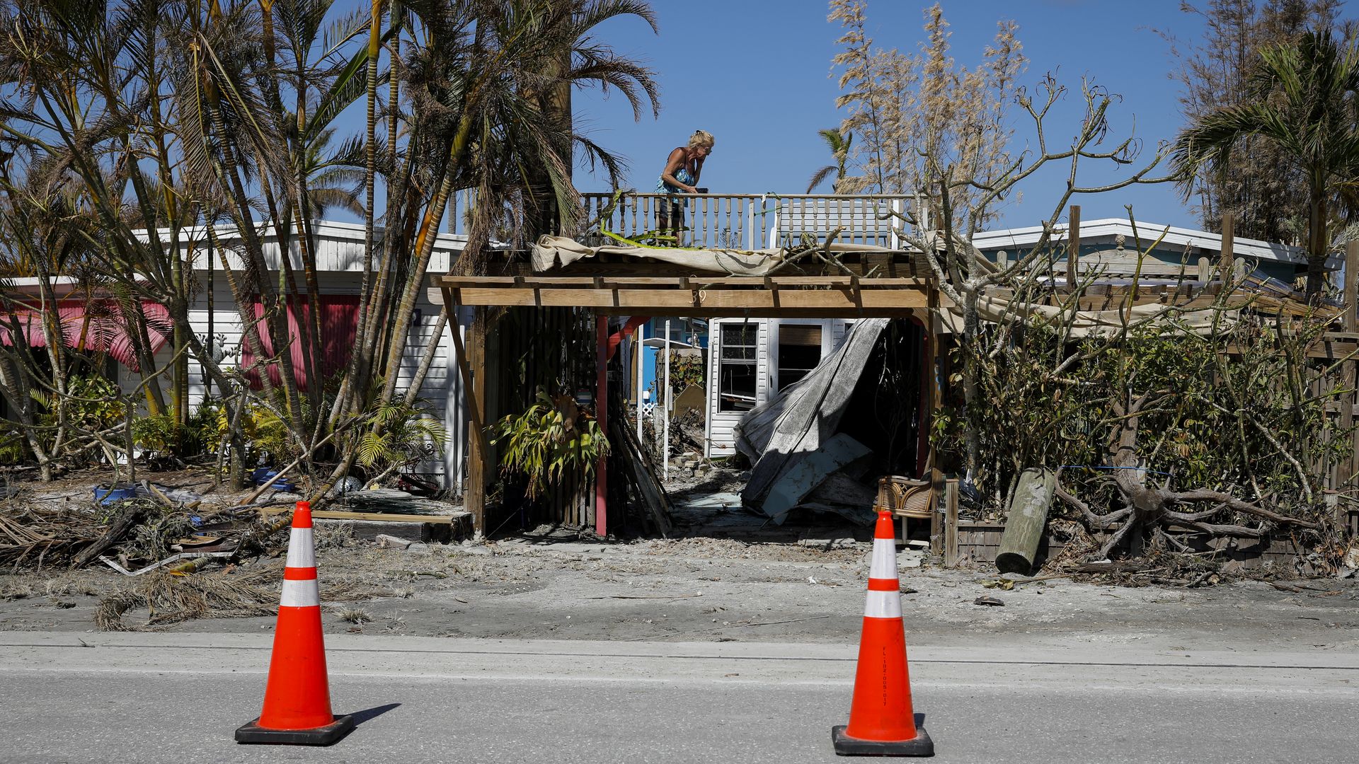  A resident takes photos of her damaged house following Hurricane Ian in Matlacha, Florida, US, on Wednesday, Oct. 5.