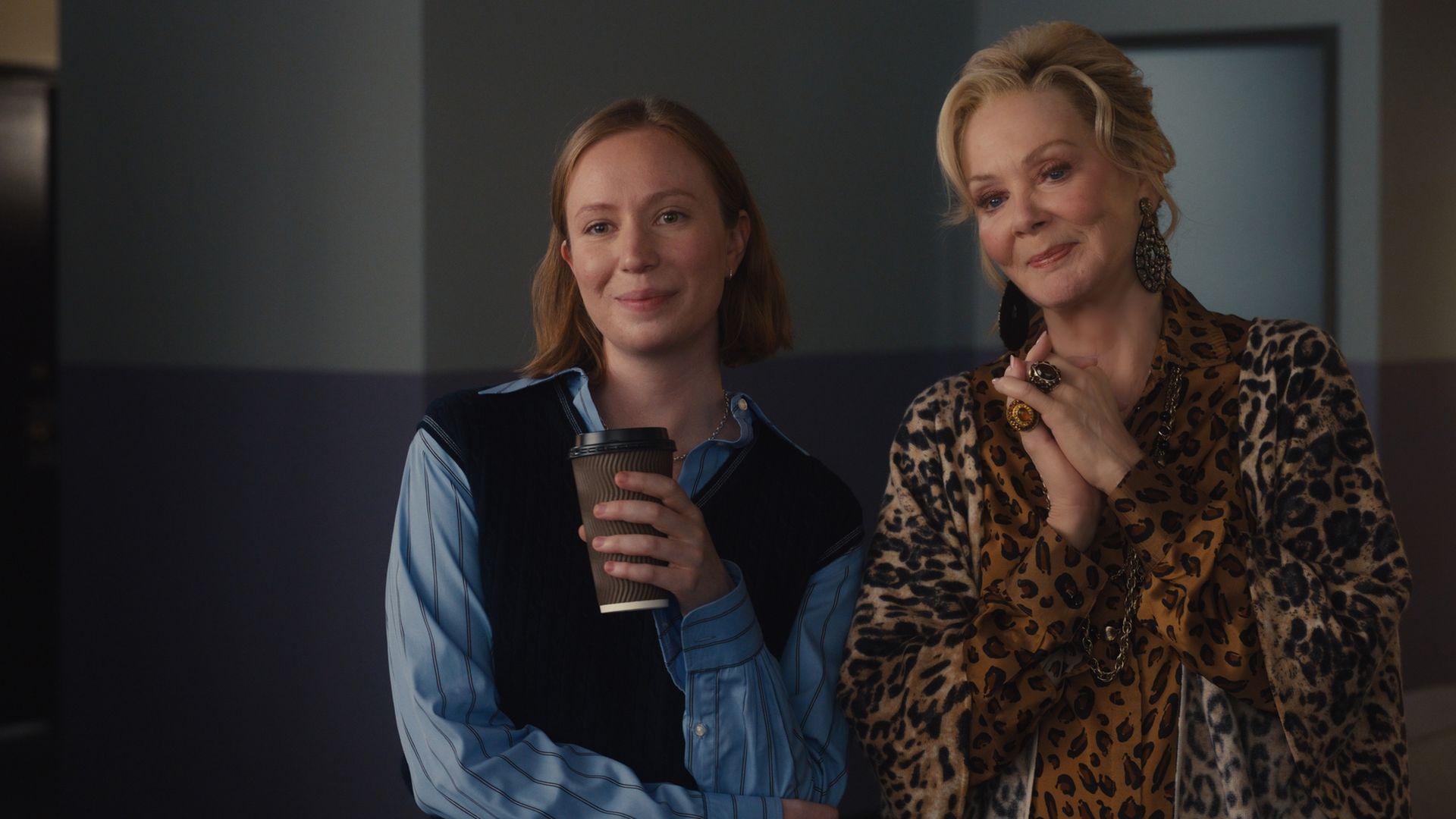 "Hacks" stars Hannah Einbinder and Jean Smart  stand next to each other and make closed-mouth smiles.