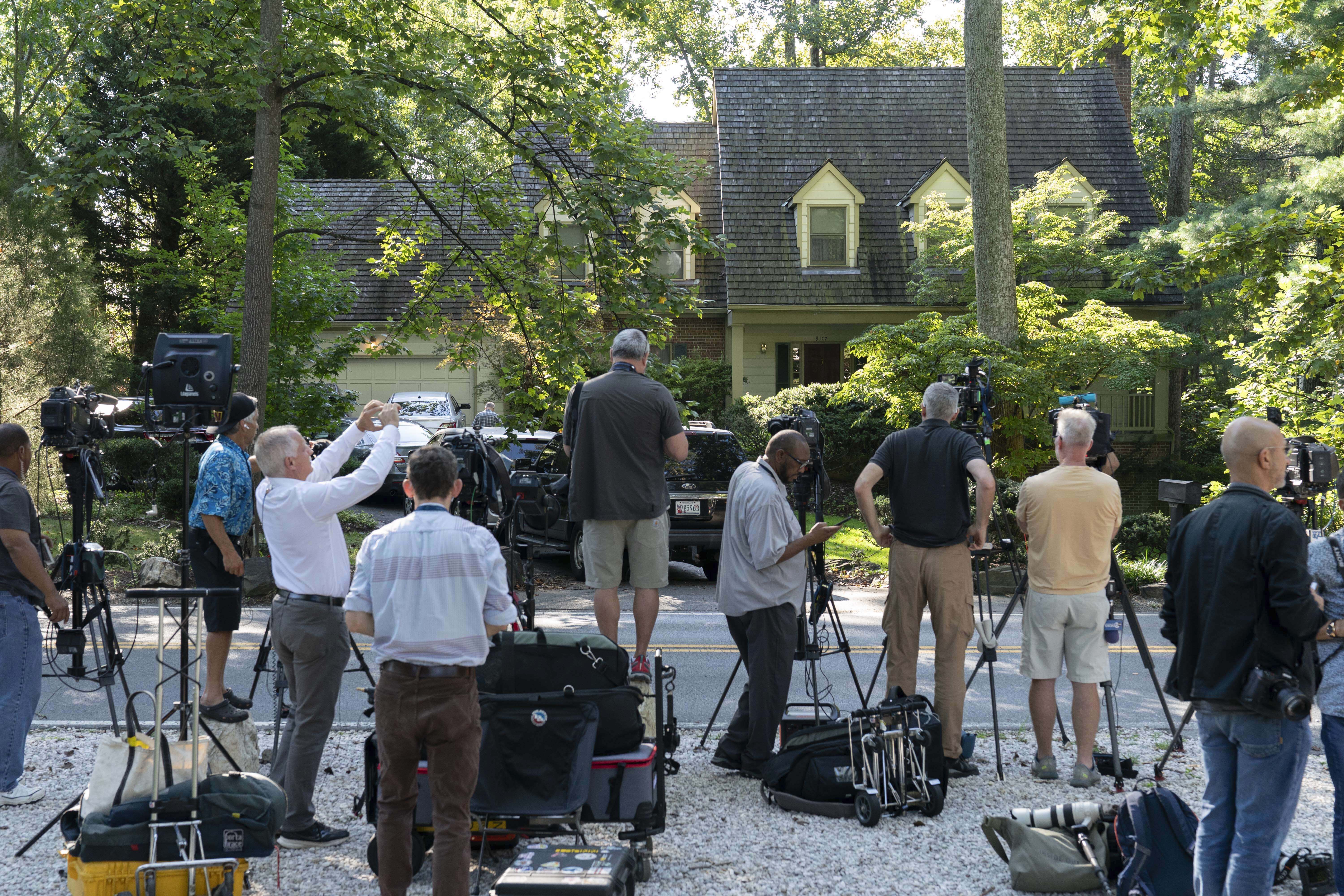 Media watch outside former national security adviser John Bolton's house as FBI agents search inside the house, Friday, Aug. 22, 2025, in Bethesda, Md. (AP Photo/Jose Luis Magana)