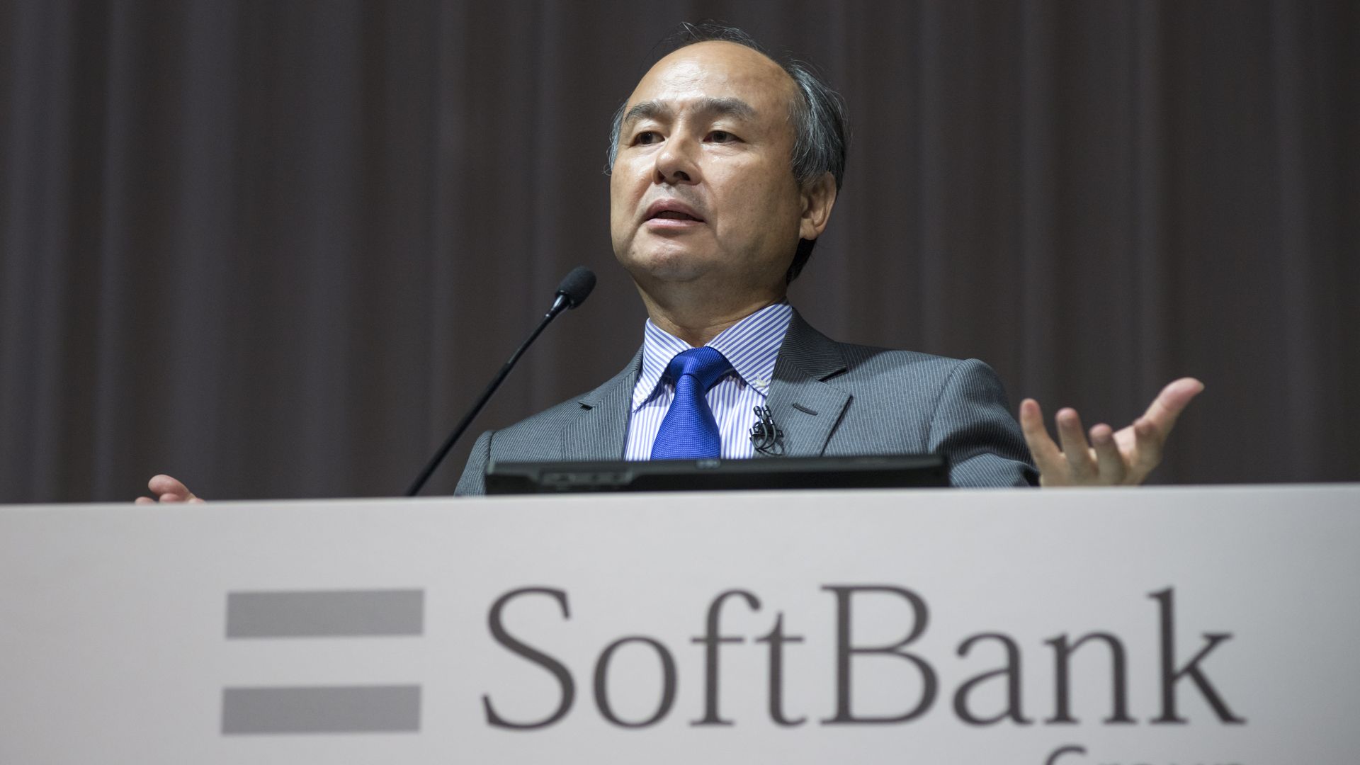 Photo of SoftBank CEO Masayoshi Son at quarterly earnings presentation.