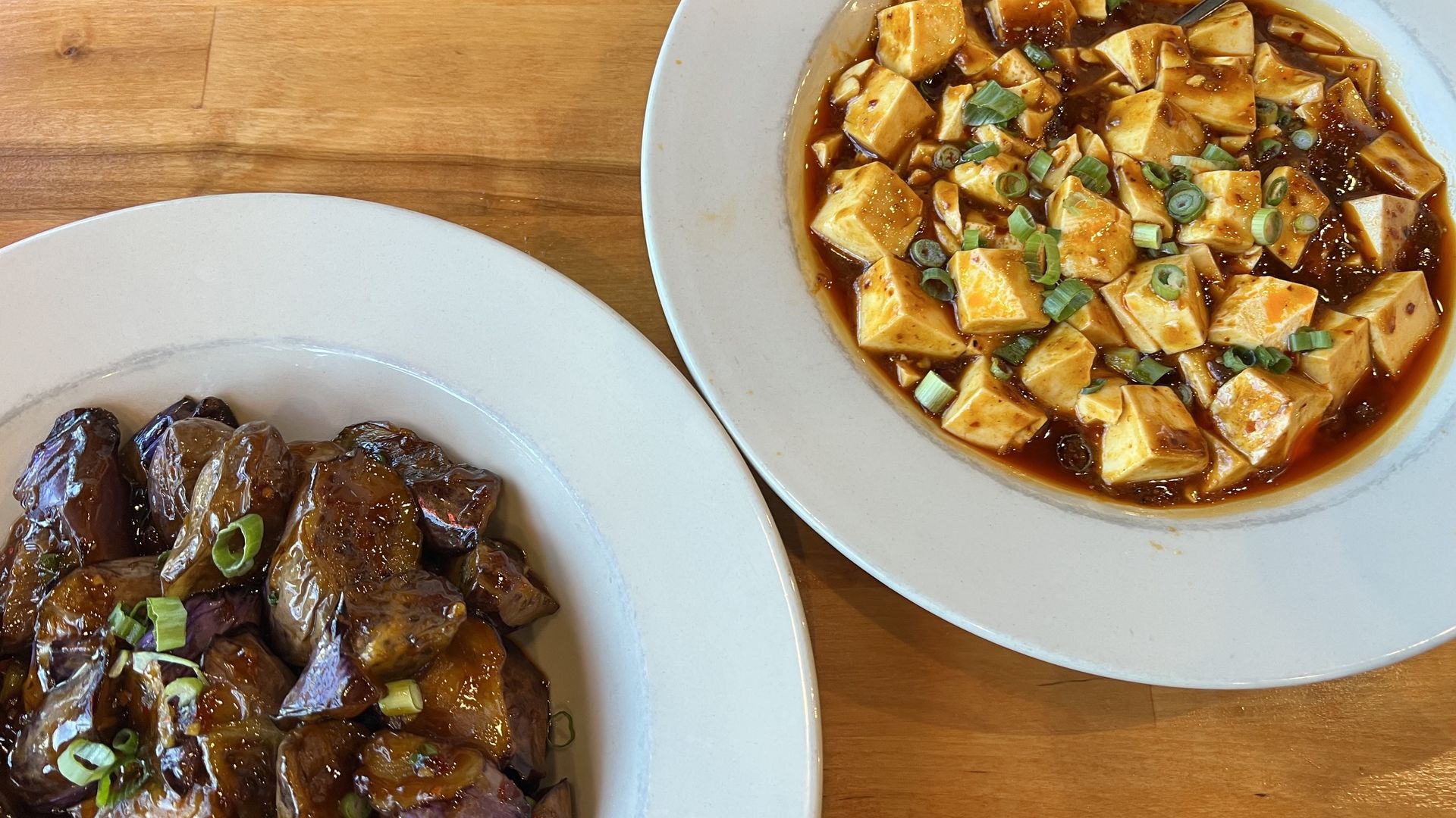 Photo of two dishes on plates: eggplant and mapo tofu