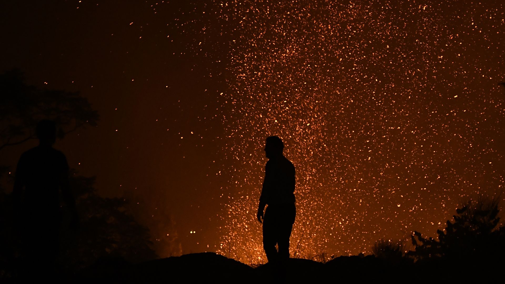 Picture of human silhouette in front of a fire 