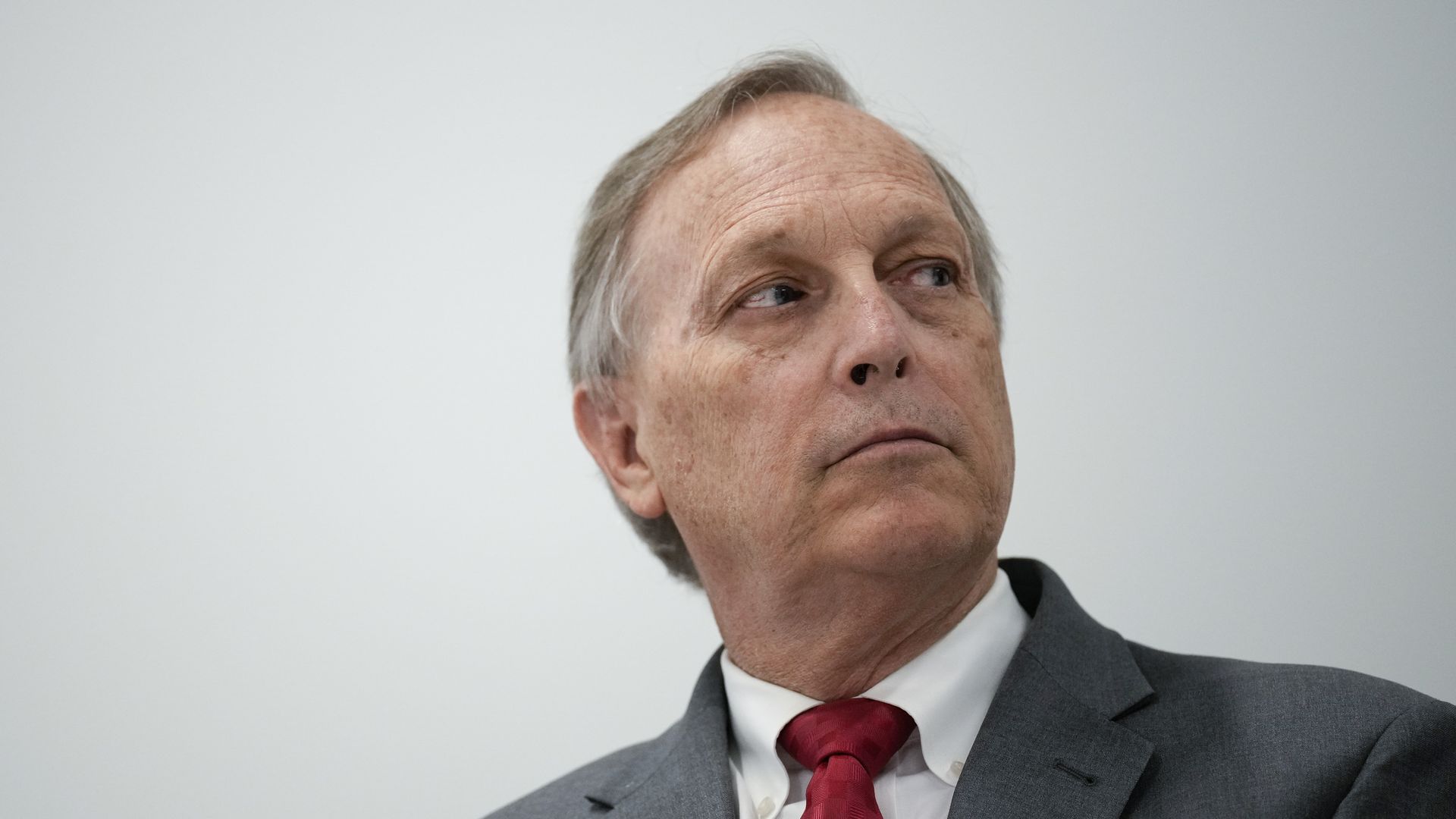 Rep. Andy Biggs, wearing a grey suit, white shirt and red tie.