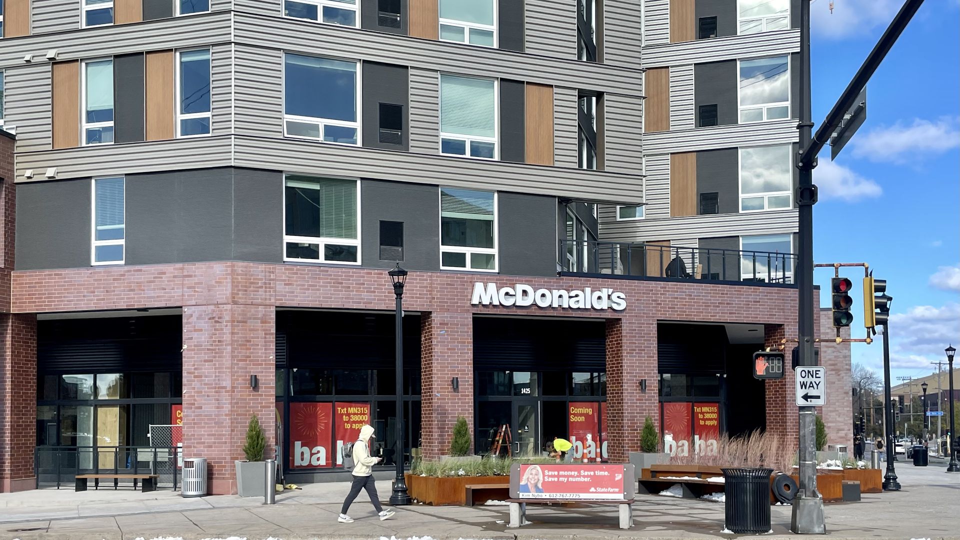 A grey apartment building with a sign that reads McDonald's.