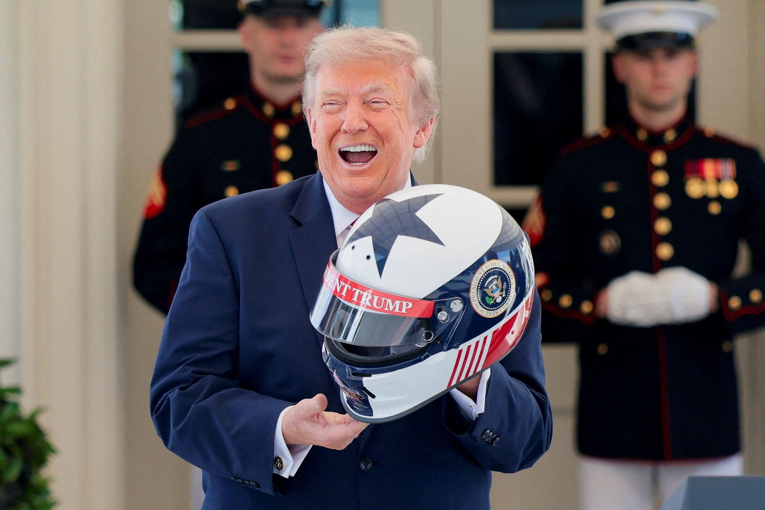 President Trump receives a personalized racing helmet during a Freedom 250 Grand Prix Showcase at the White House yesterday.