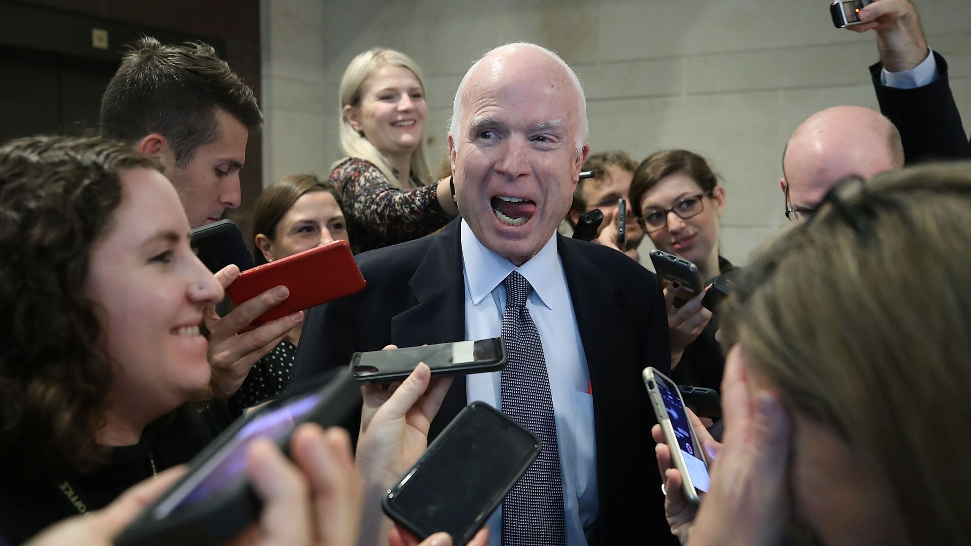 John McCain laughing with reporters