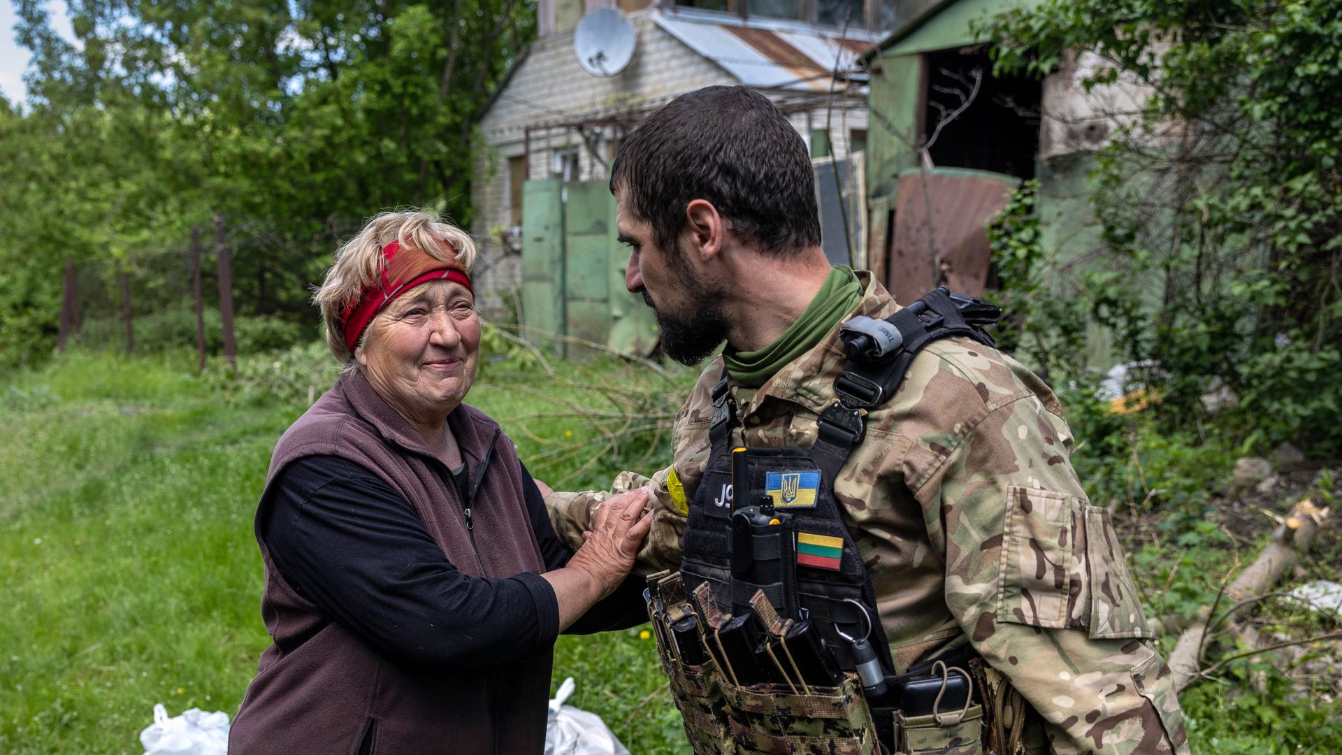 A local resident thanks volunteers delivering humanitarian food aid to isolated areas on May 23, 2022 in Vilkhivka, Ukraine.