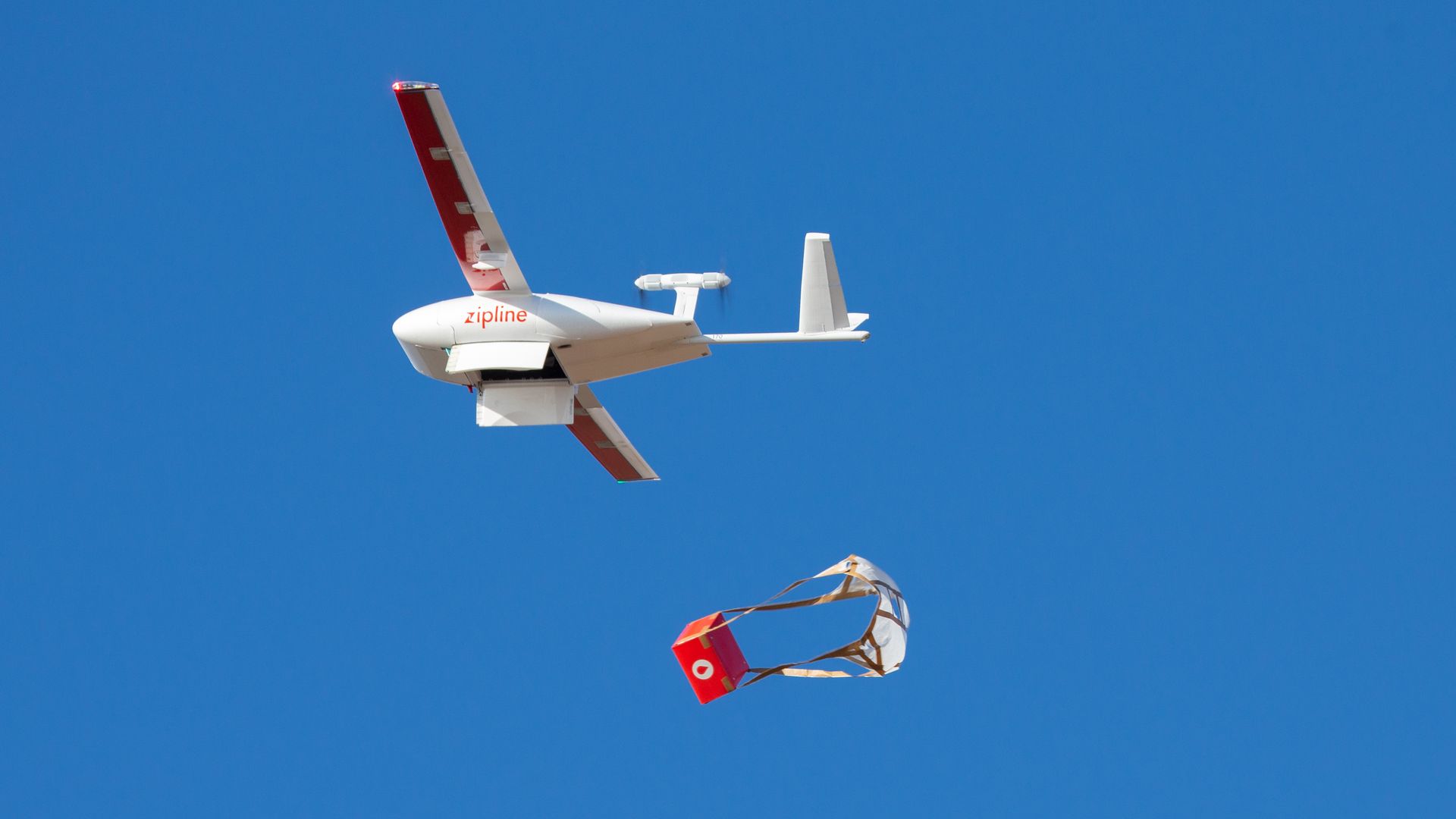Image of a Zipline drone delivering a package of medical supplies in Ghana