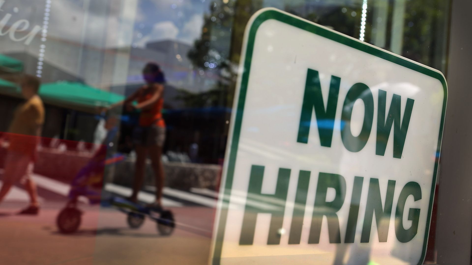 Sign in a window that reads "Now Hiring."