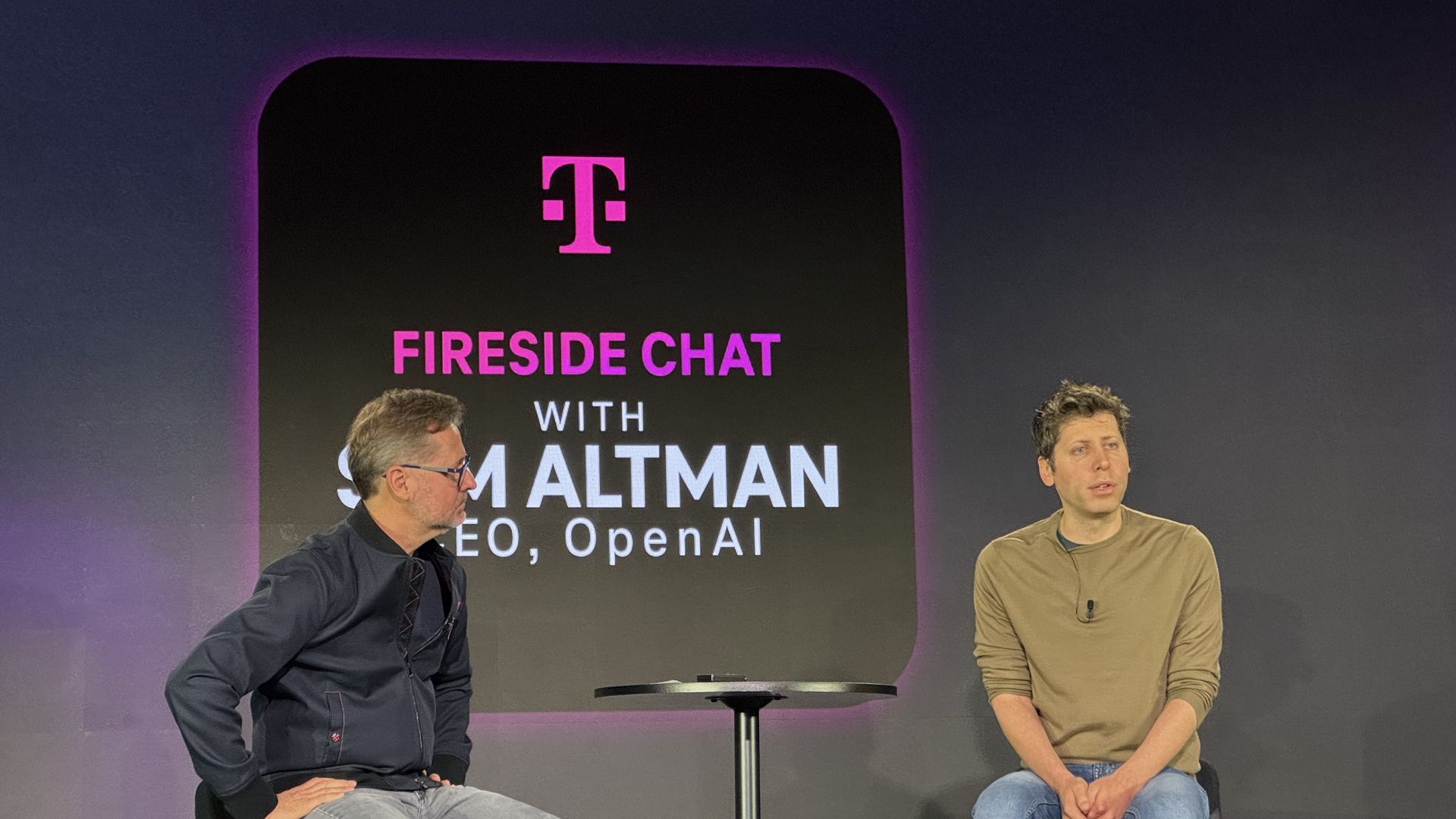 T-Mobile CEO Mike Sievert talks to OpenAI CEO Sam Altman at T-Mobile's Capital Markets Day on Wednesday.