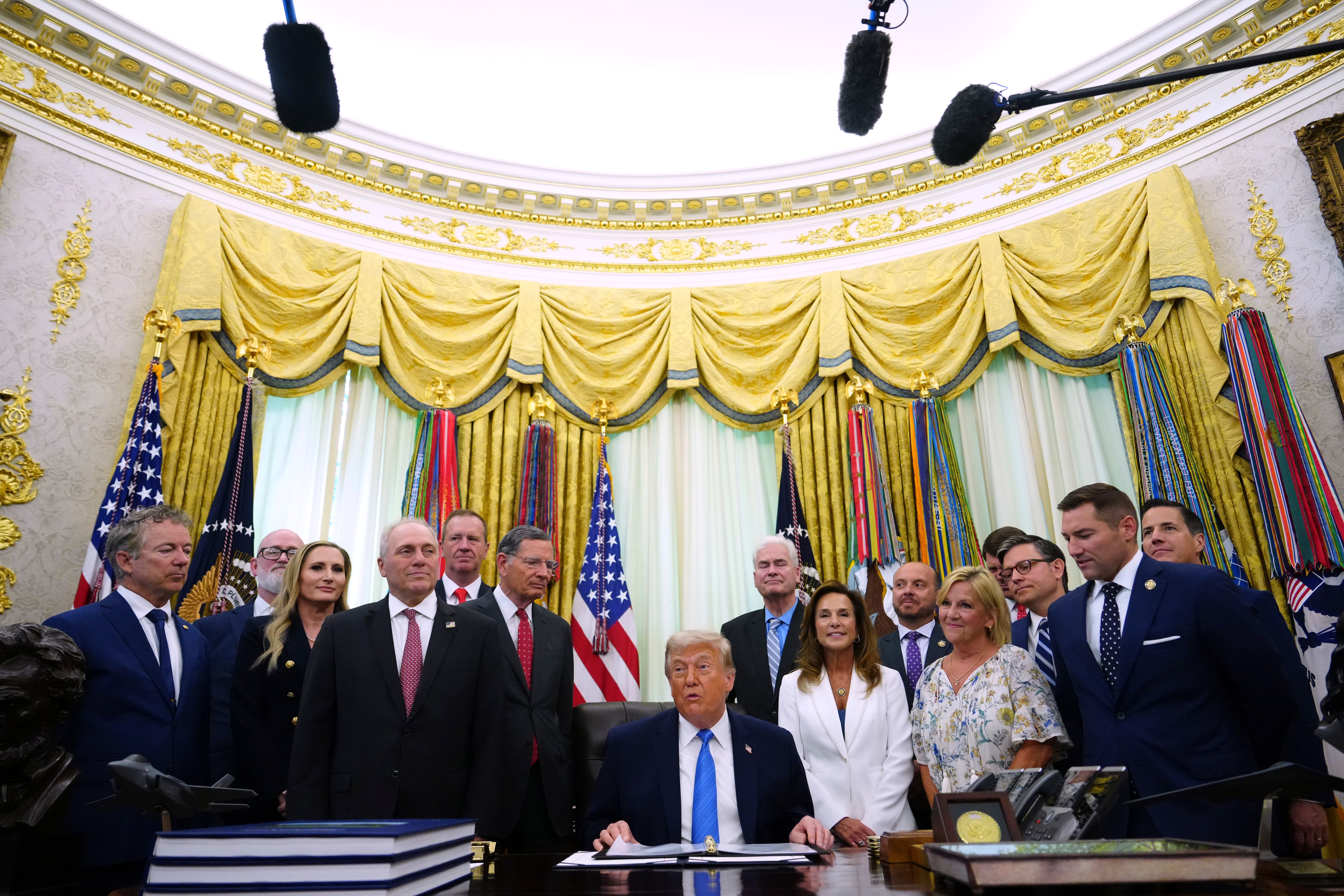 President Trump speaks to reporters during an executive order signing in the Oval Office yesterday.