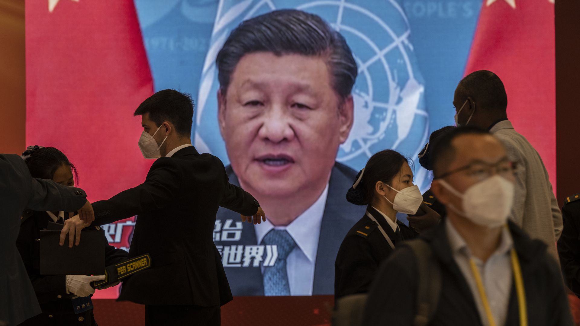 A video screen shows Chinese President Xi Jinping as security check visitorson October 15, 2022 in Beijing, China.