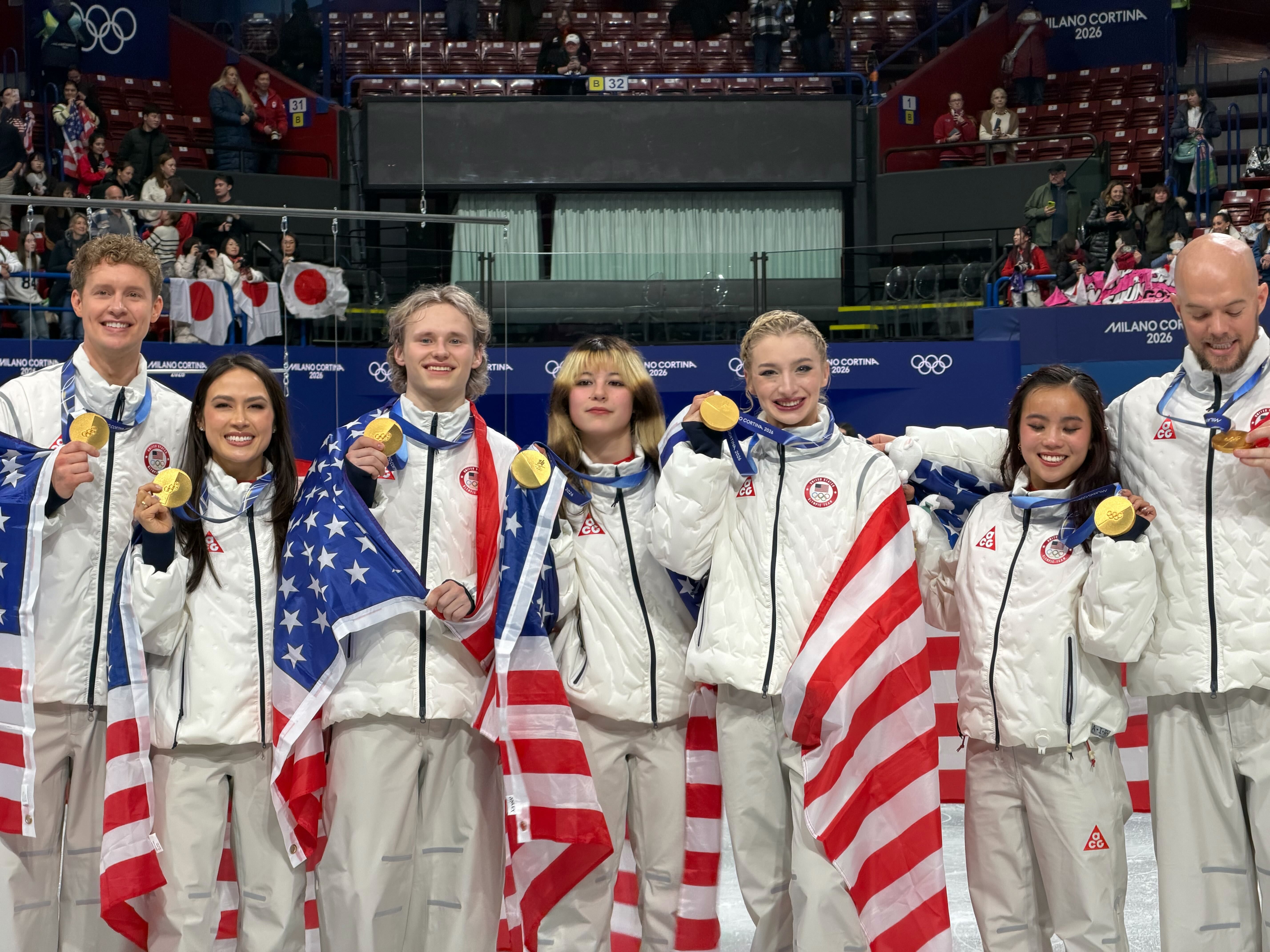 U.S. figure skaters celebrate winning the gold in the team event.