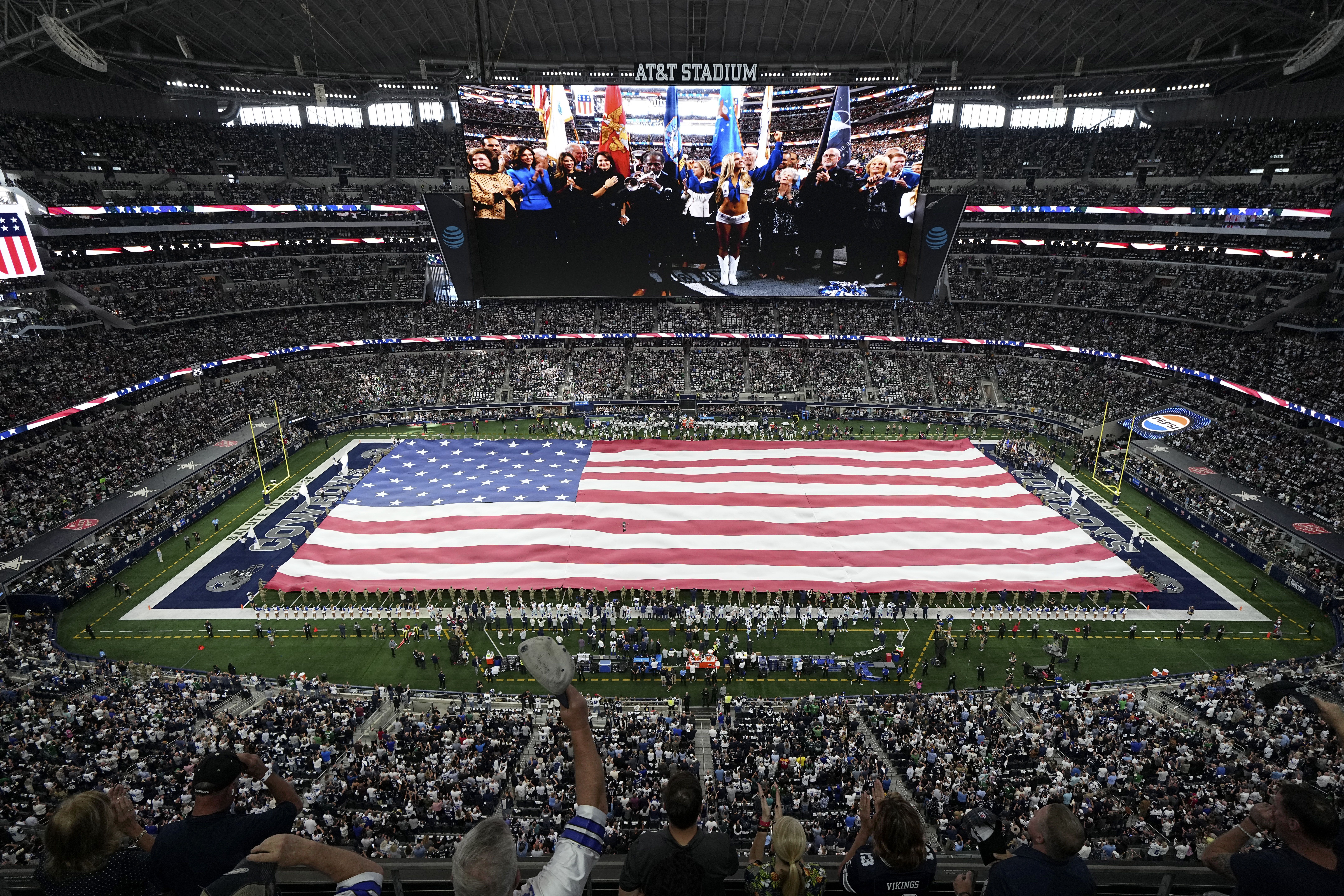 An American flag is displayed on the fild at AT&T Stadium during the playing of the national anthem before an NFL football game between the Philadelphia Eagles and Dallas Cowboys in Arlington, Texas, Sunday, Nov. 10, 2024.