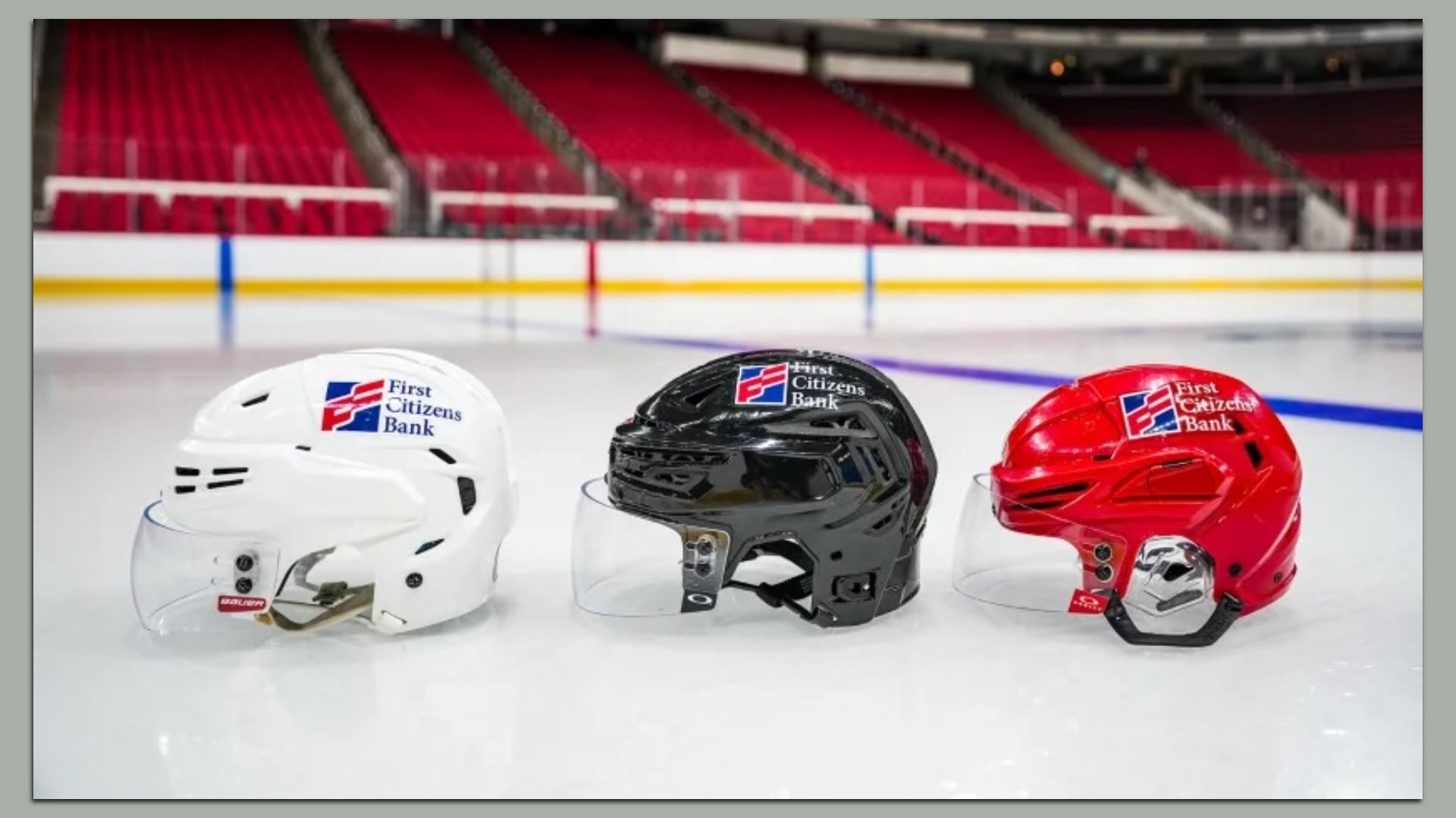 Three helmets in white, black and red with the First Citizens Bank logo on it