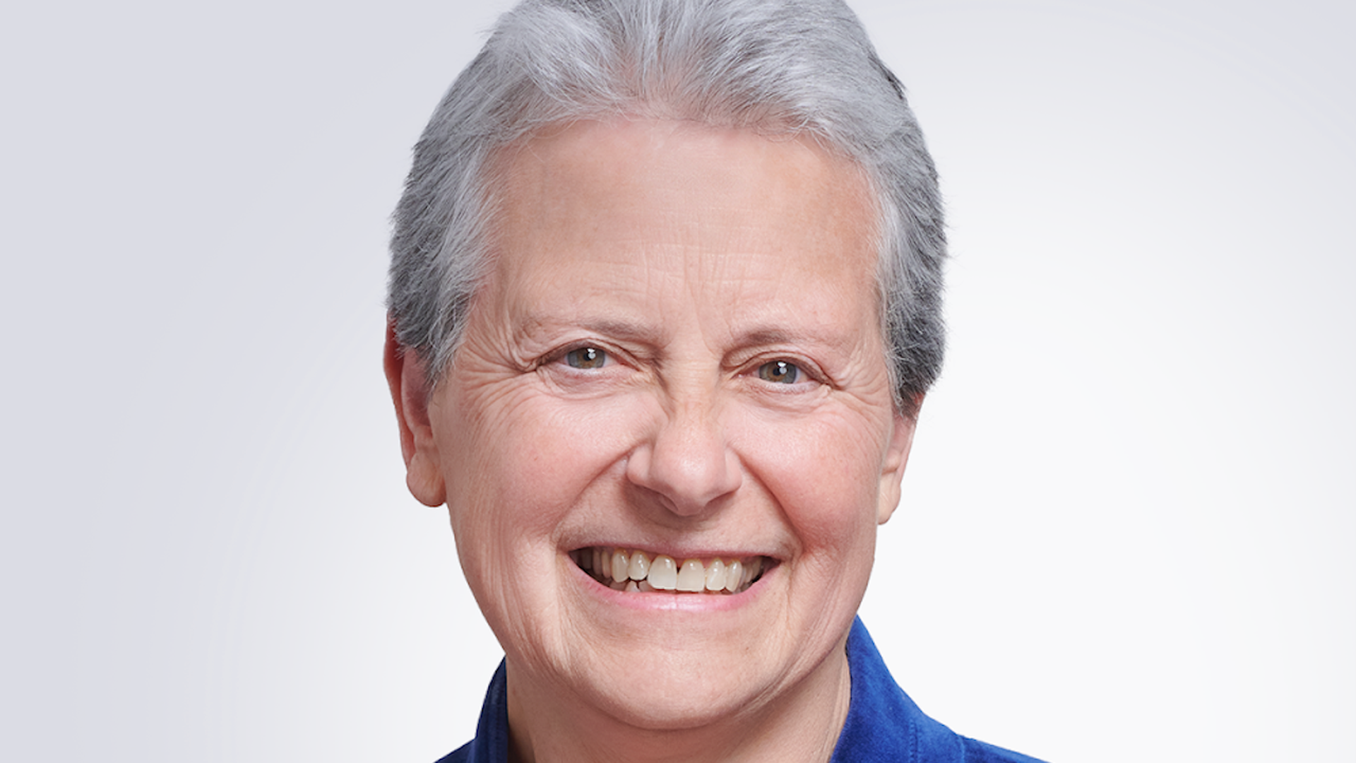 Stefania Mallett, CEO of corporate food startup ezCater, poses for a headshot wearing a blue blazer as she stands in front of a white background. 