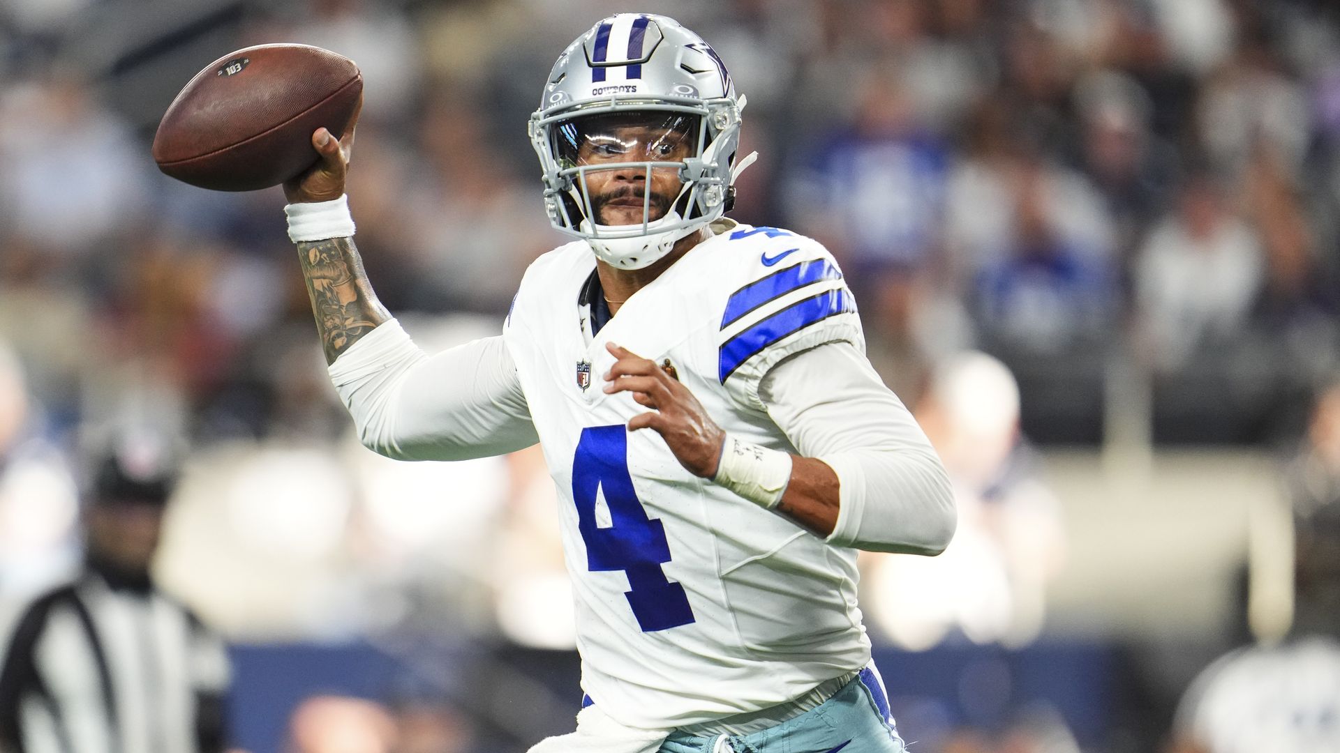 A photo of Dak Prescott throwing a ball in a game