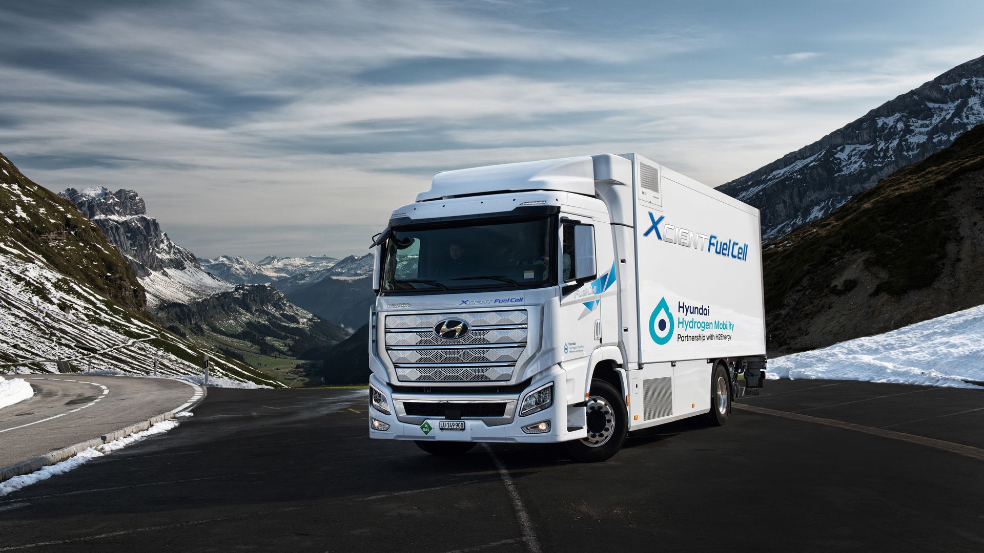 Image of Hyundai XCIENT fuel cell truck on a road in a snowy mountain range