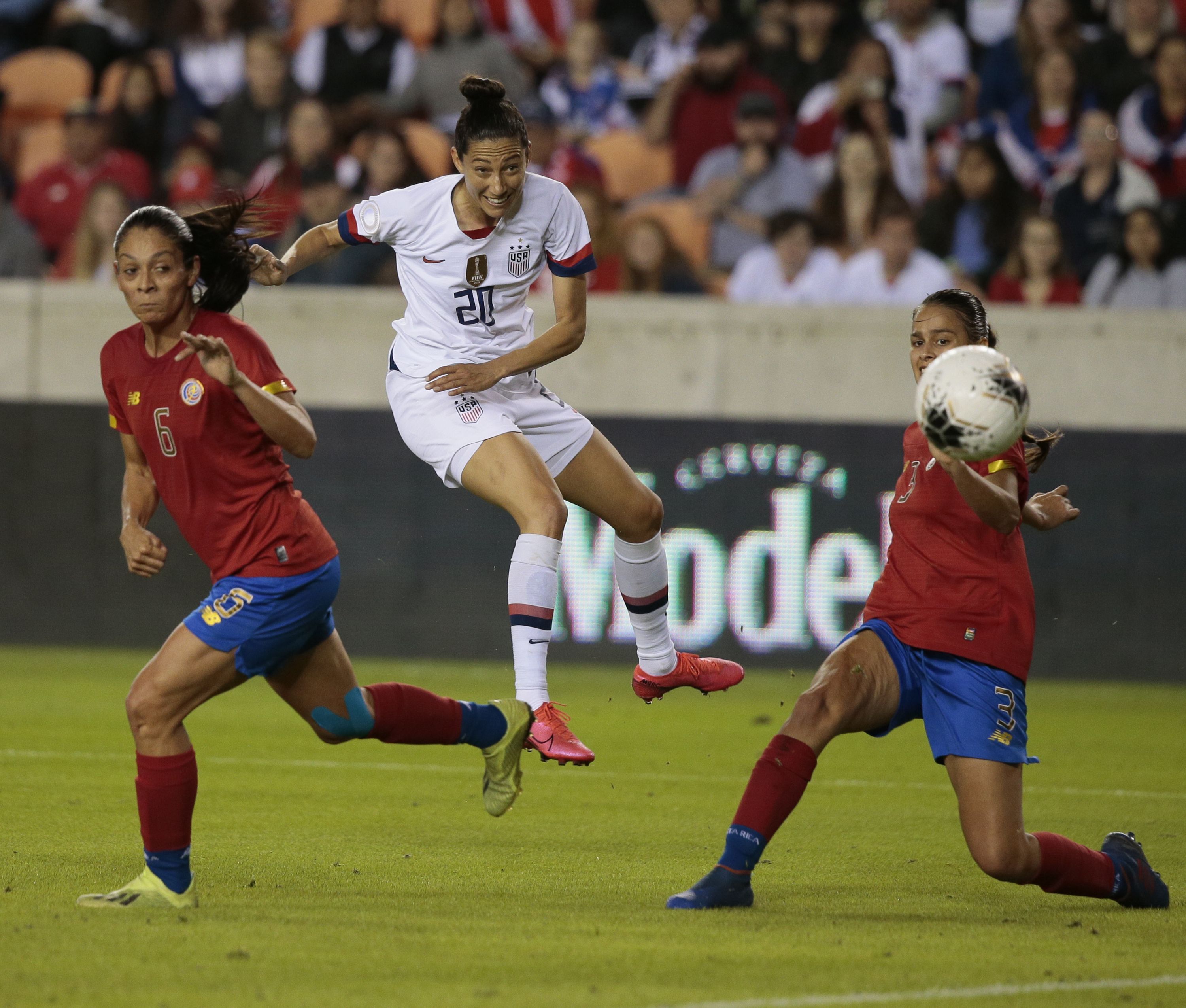 Christen Press kicks the ball at the goal