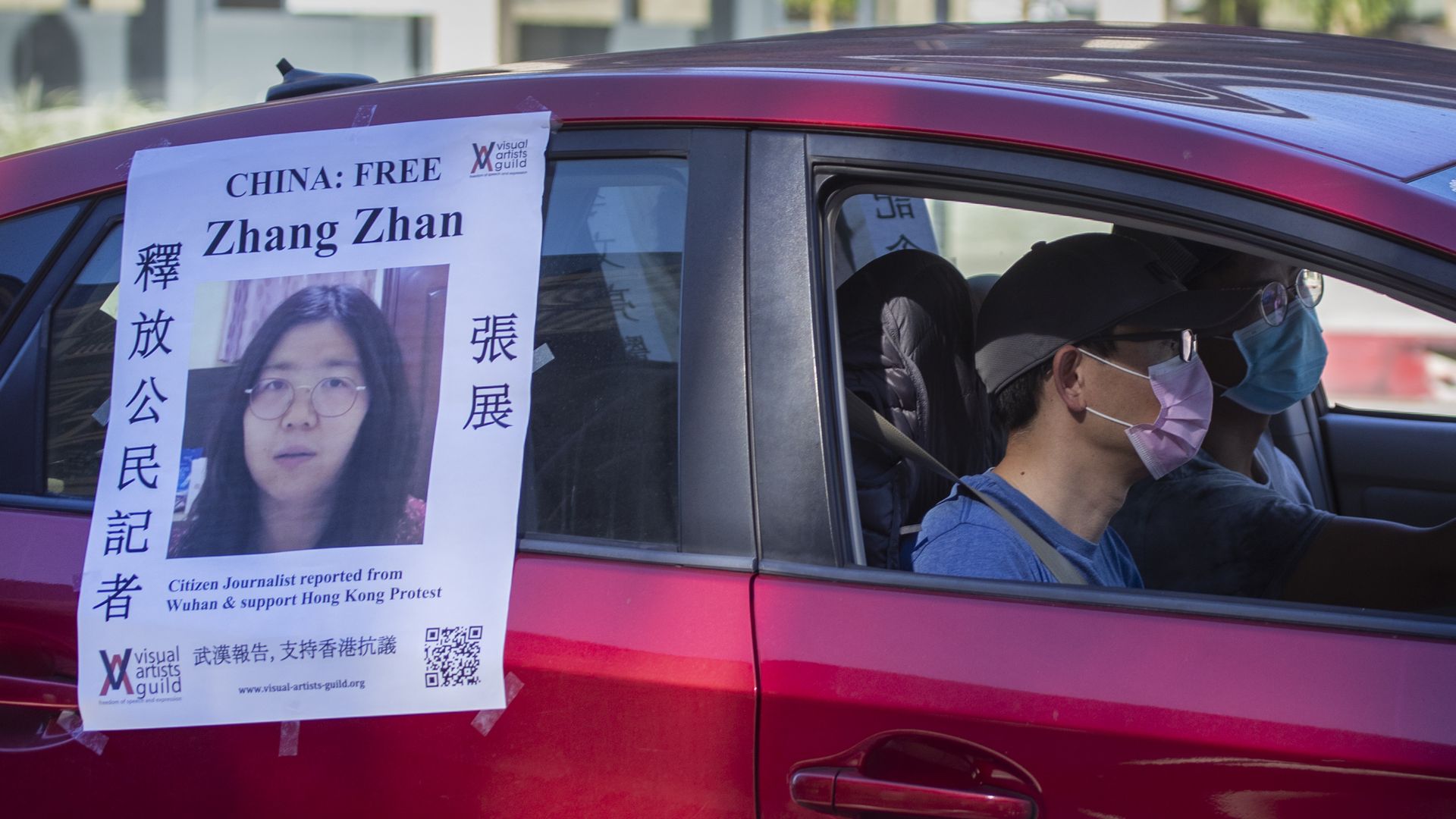 A car displaying a poster of jailed Chinese citizen journalist Zhang Zhan follows a caravan funeral procession in Pasadena, Los Angeles, honoring COVID-19 victims in November. 