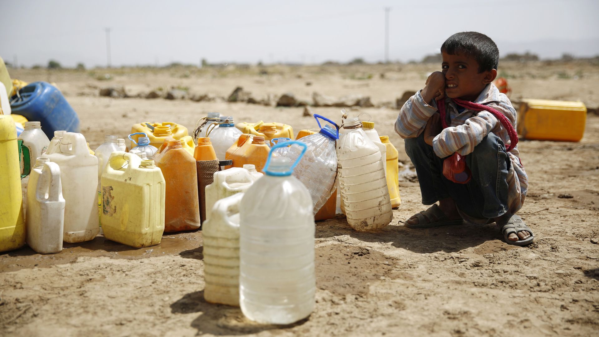 A boy waits for his turn to fill buckets with water from a public tap amid an acute shortage of water, on the outskirts of Sanaa, Yemen. 
