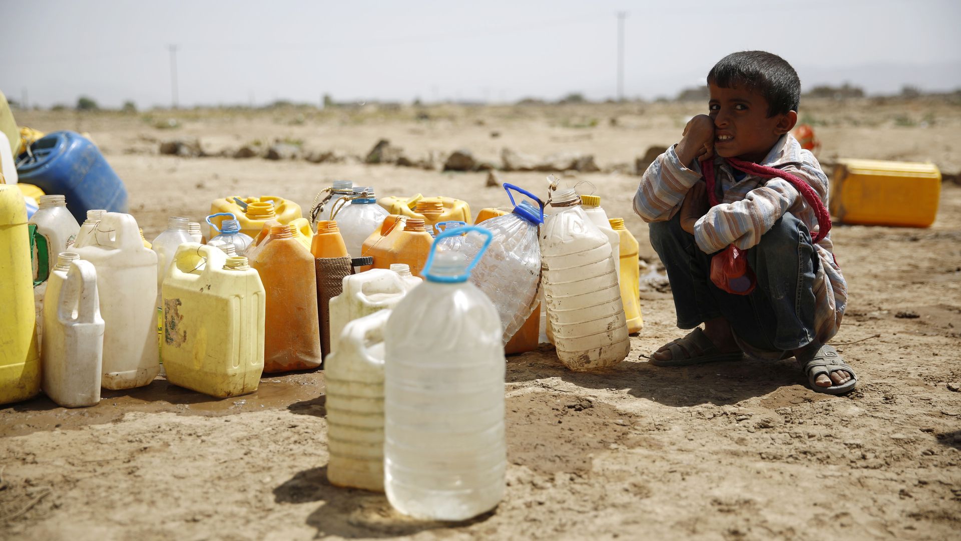 A boy waits for his turn to fill buckets with water from a public tap amid an acute shortage of water, on the outskirts of Sanaa, Yemen.