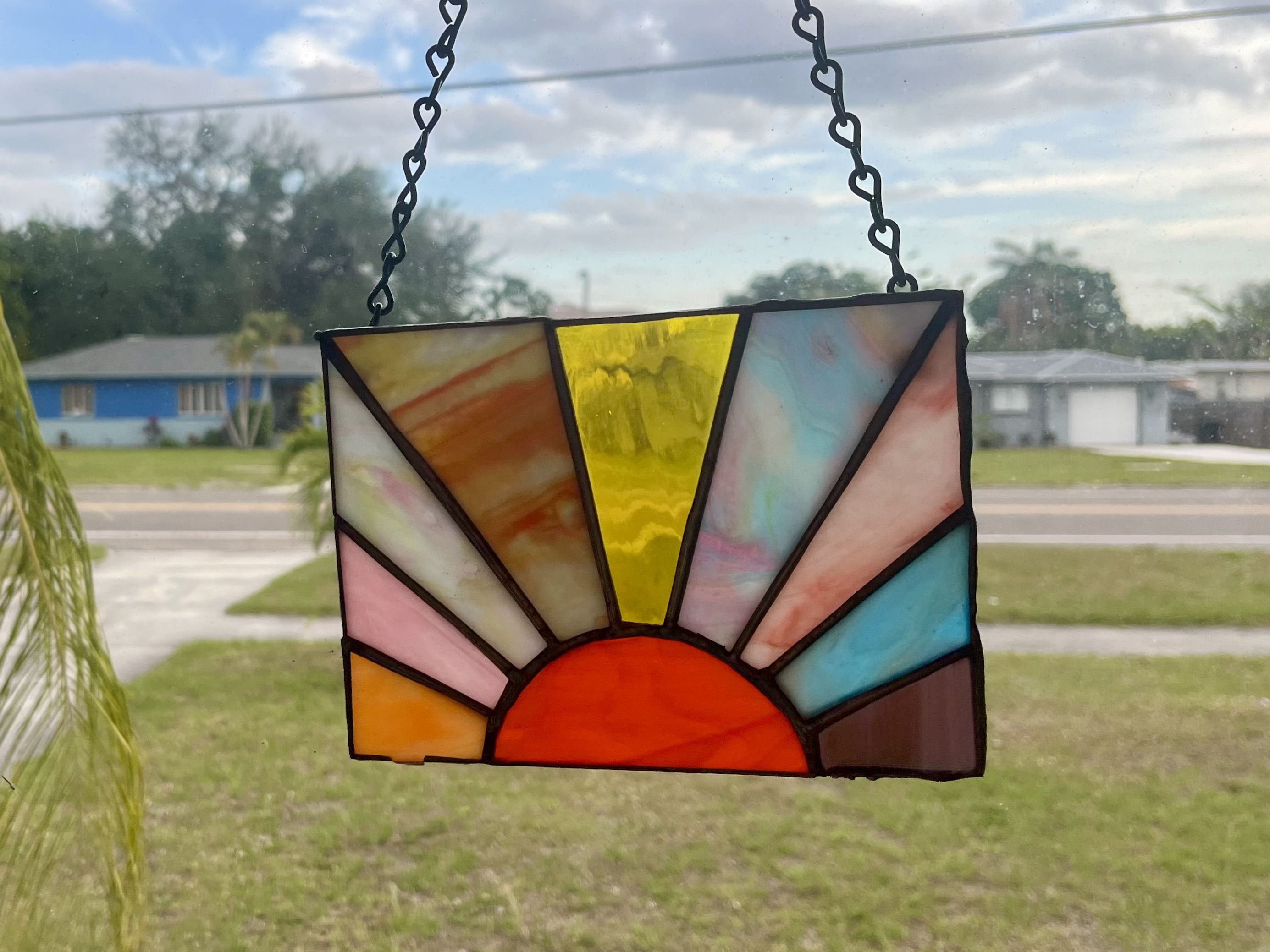 A stained glass piece of a setting sun. 