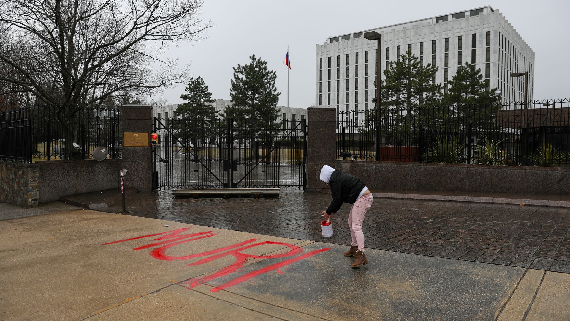 A woman is seen painting the word 