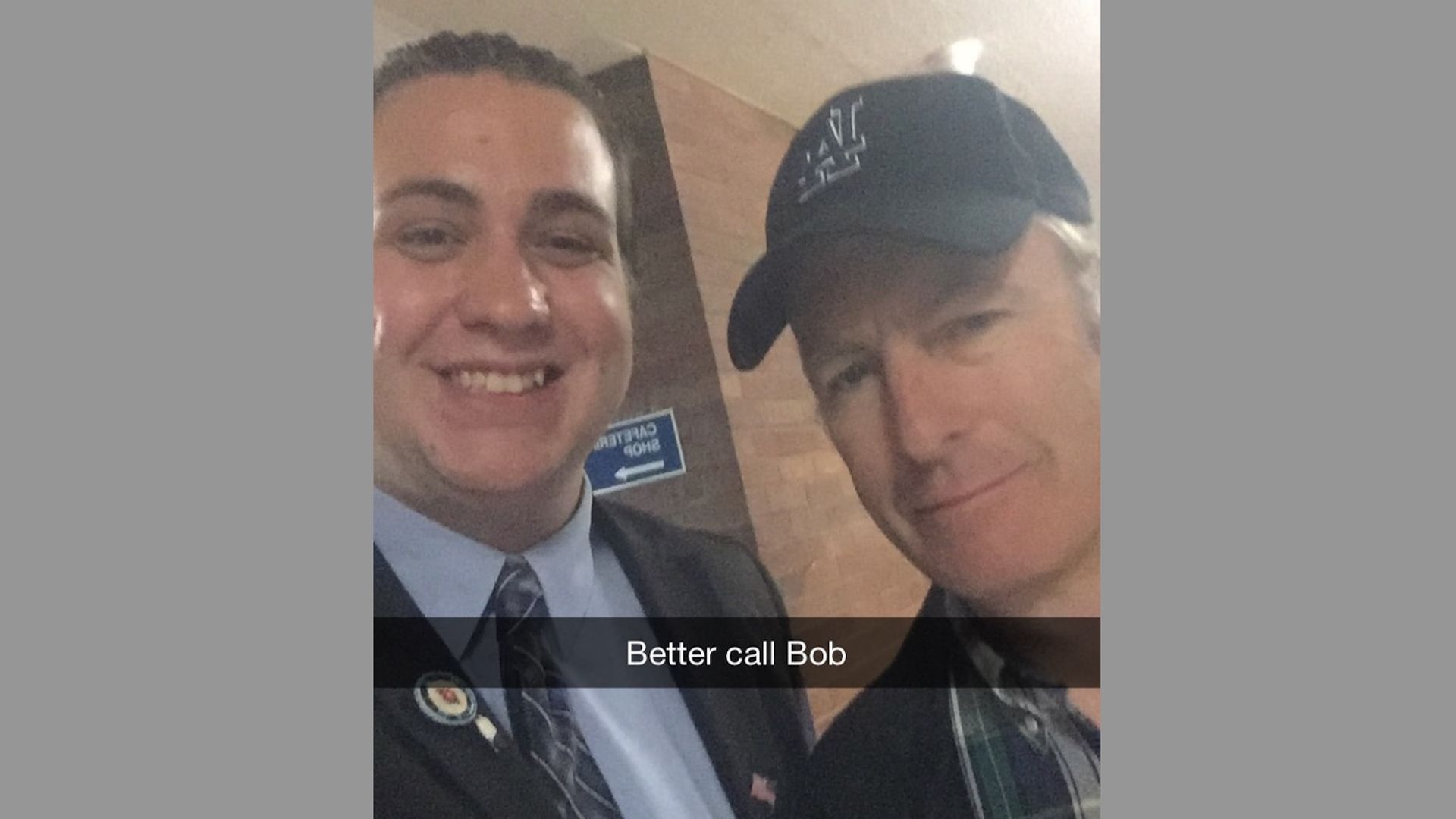 The actor Bob Odenkirk poses for a selfie with a teenage fan in a high school hallway.