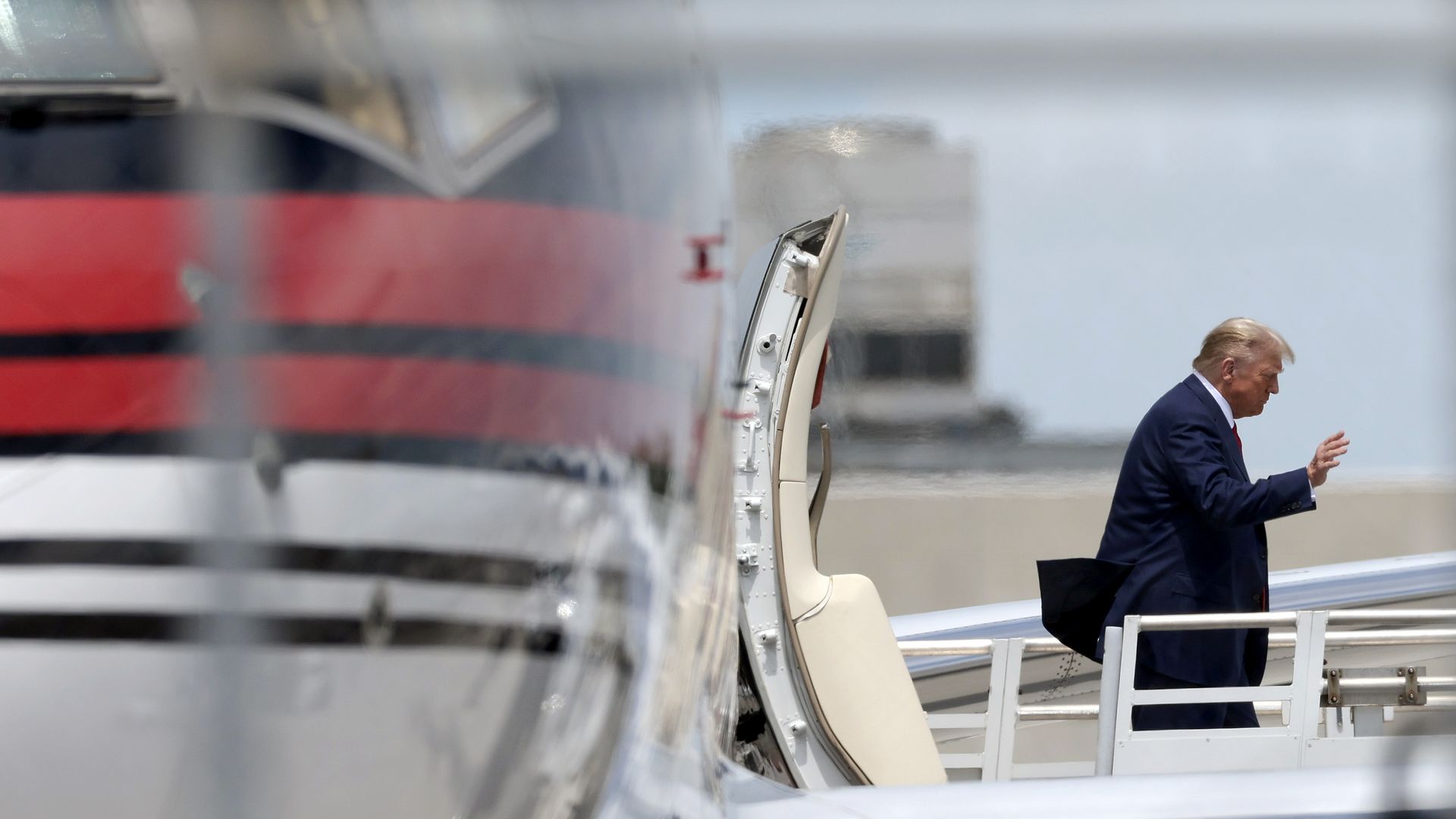 Trump walking off an airplane