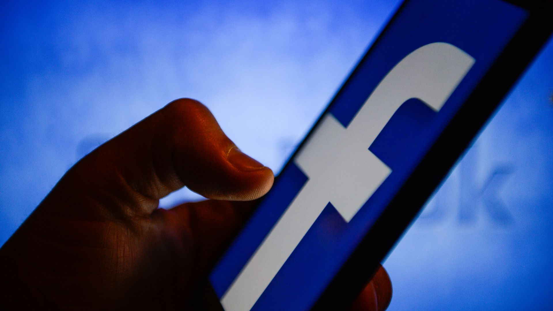 Image of a person pulling up the Facebook app