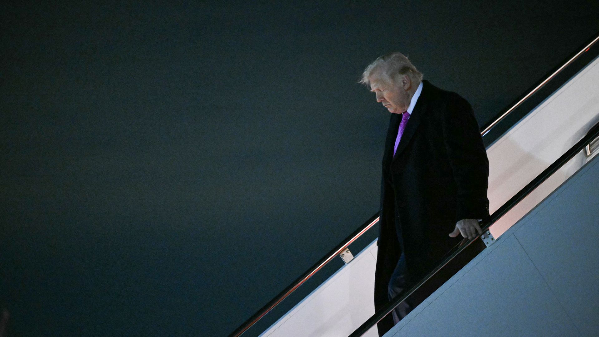 President Donald Trump steps off Air Force One at Joint Base Andrews in Maryland after a weekend trip.