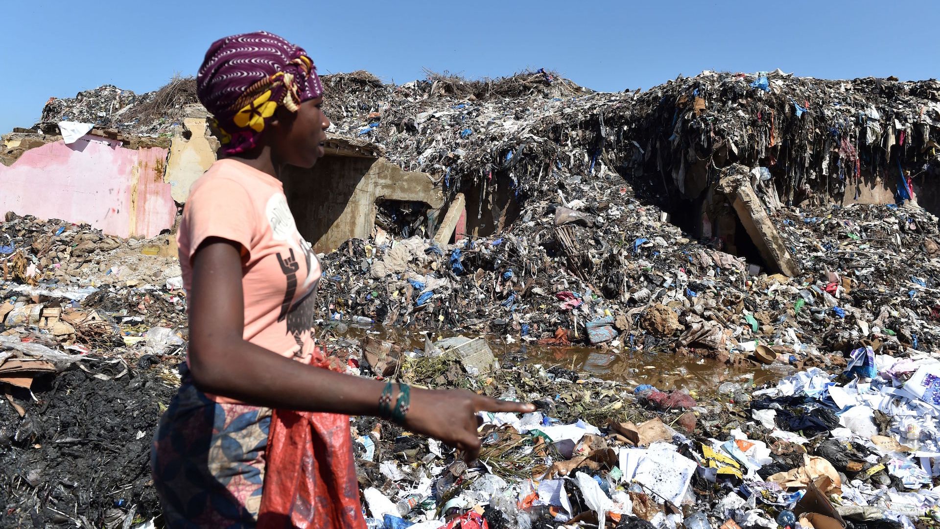 A woman looks for valuables in a rubbish dump containing plastics pollution in Bamako on August 16, 2018. 