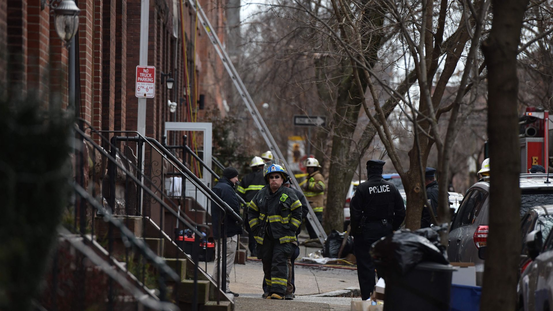A firefighter stands near the scene of Philadelphia's Fairmount fire.