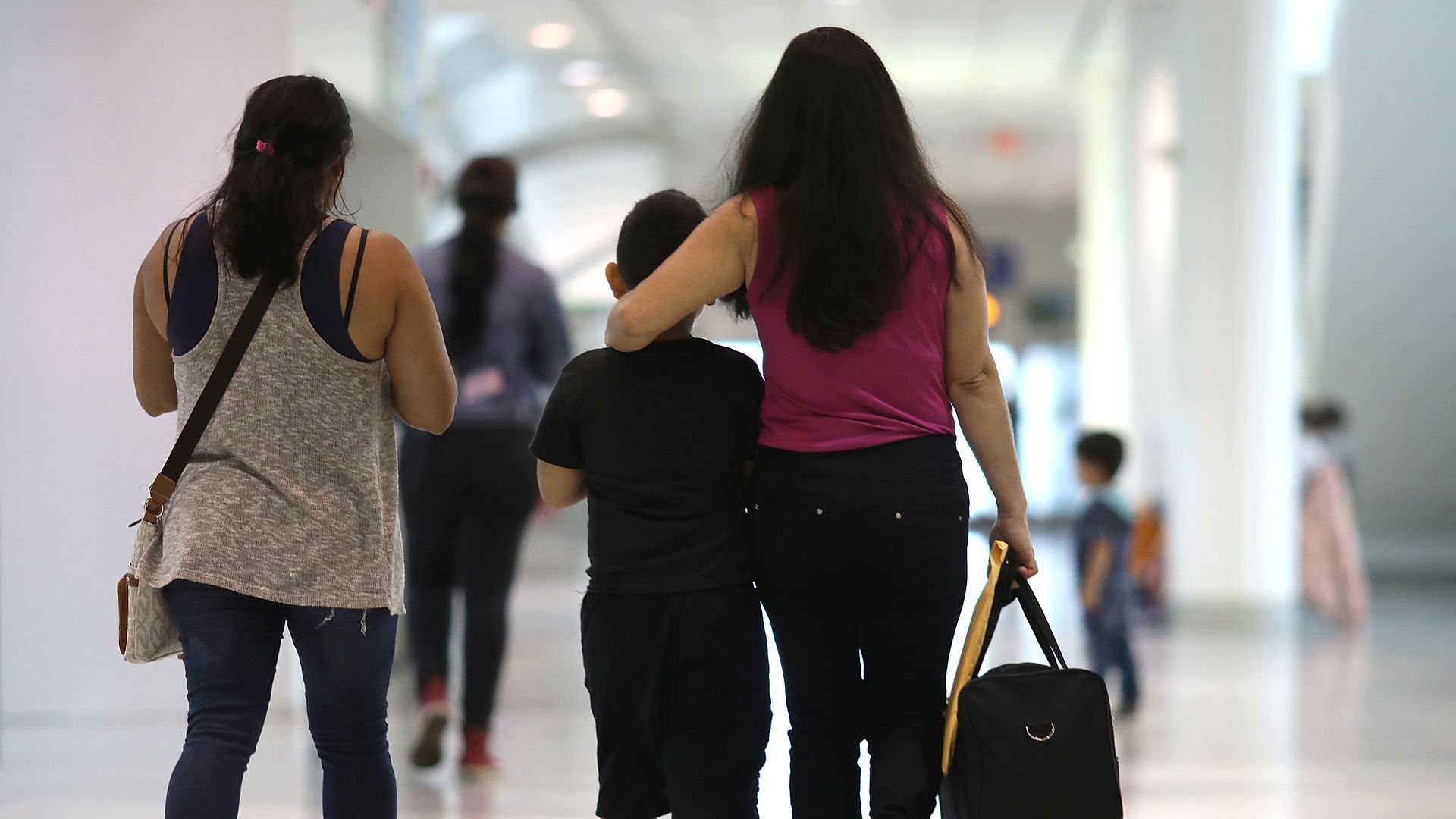 A 7-year-old boy reunited with his mother at Baltimore-Washington International Airport in Linthicum, Maryland. Photo: Win McNamee/Getty Images