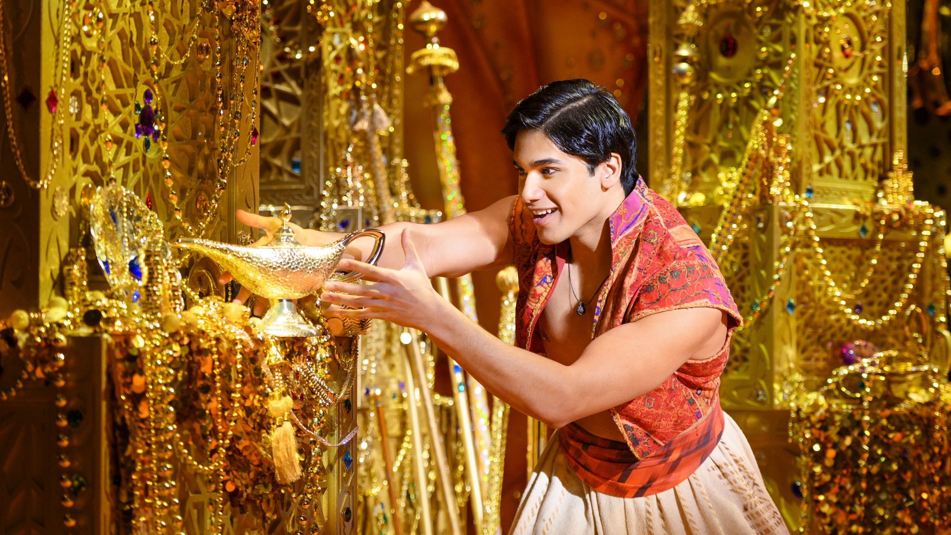 The character of Aladdin rubs a gold lamp in the Broadway musical version of Disney's "Aladdin."
