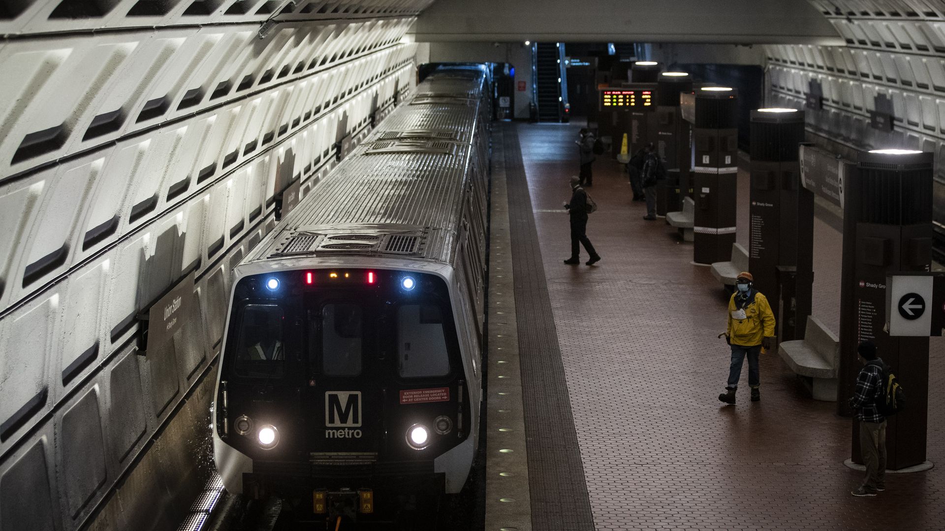 A Metro train pulls up to a fairly empty station.