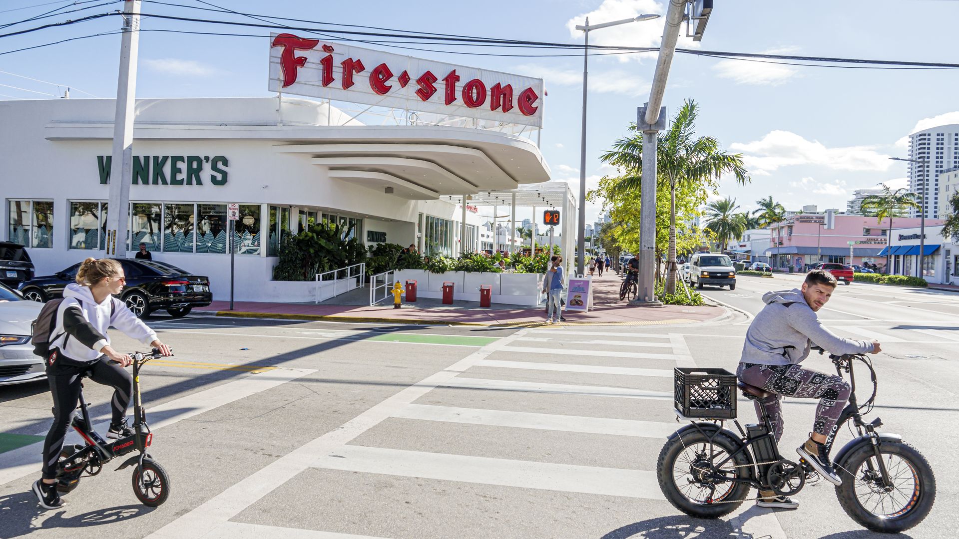 Miami Beach, Florida, former Firestone Tire store converted to a restaurant with people on electric bikes. (Photo by: Jeffrey Greenberg/UCG/Universal Images Group via Getty Images)