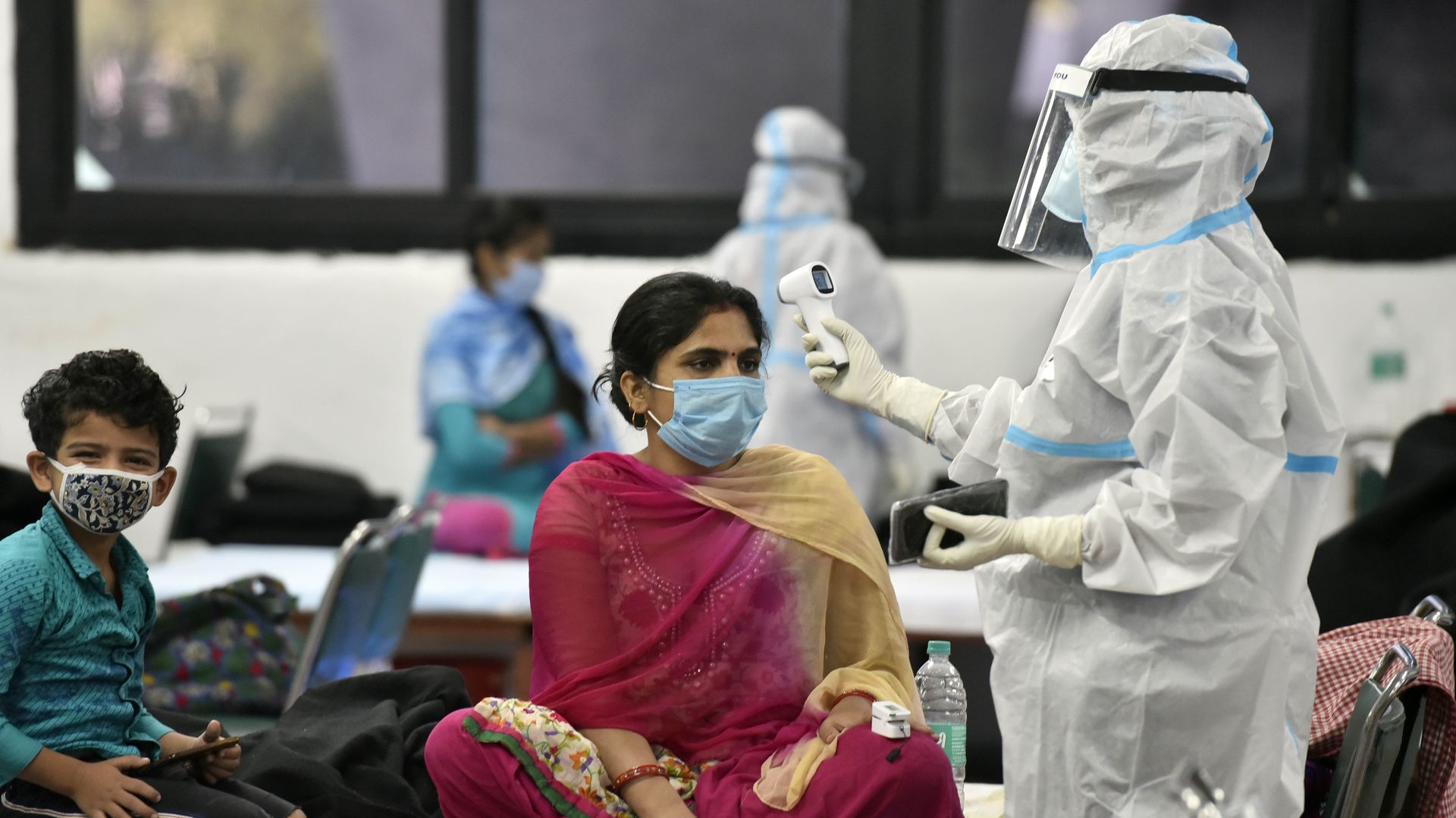 A health worker checks vitals of a coronavirus patient inside the Commonwealth Games (CWG) Village Covid Care Centre, on September 27, 2020 in New Delhi, India.