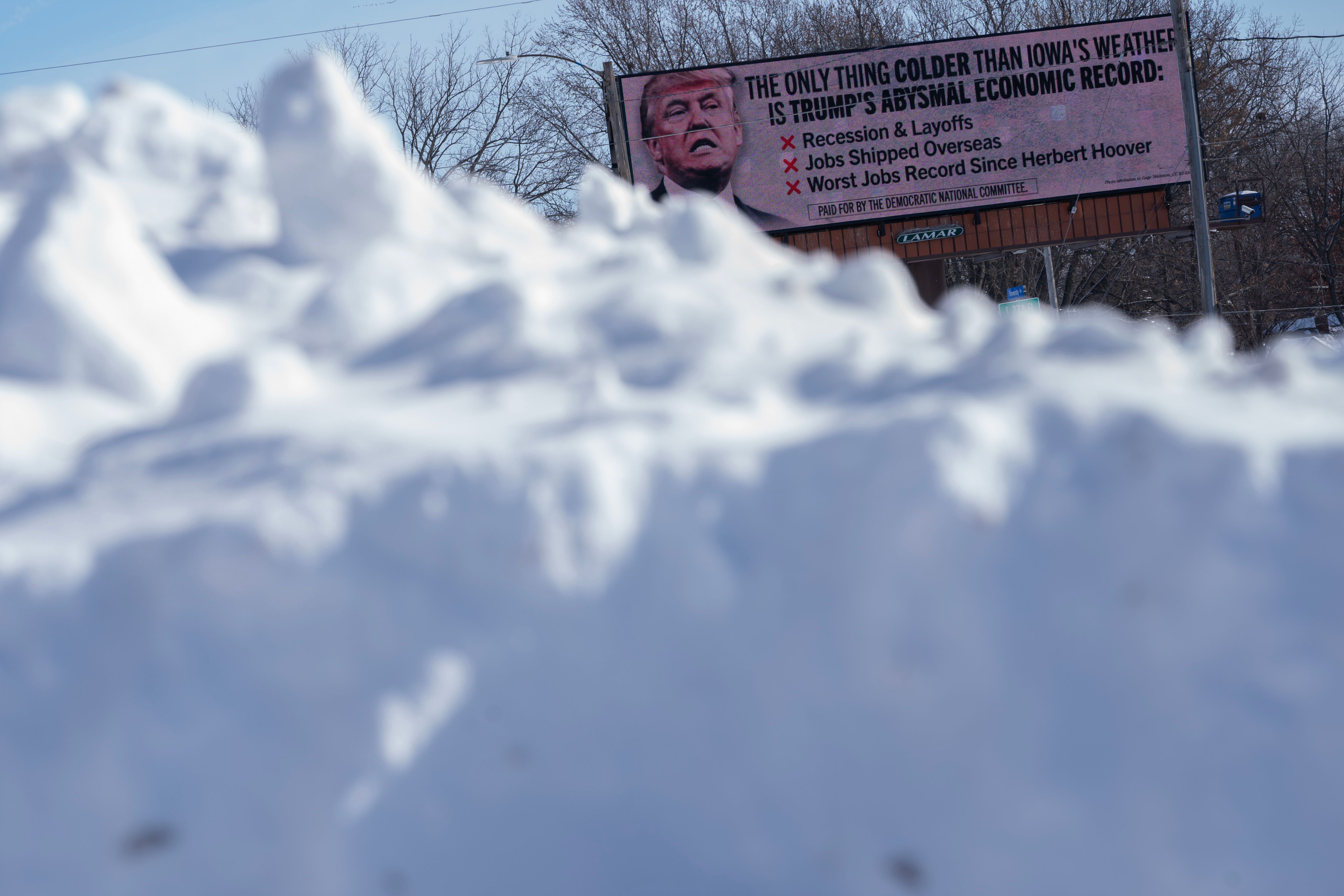 A billboard targeting former US President Donald Trump ahead of the Iowa caucus in Des Moines, Iowa, US, on Sunday, Jan. 14, 2024. Iowans on Monday will cast the first votes in the 2024 presidential nominating process during a caucus that's likely to show depressed turnout because of historically frigid weather. 