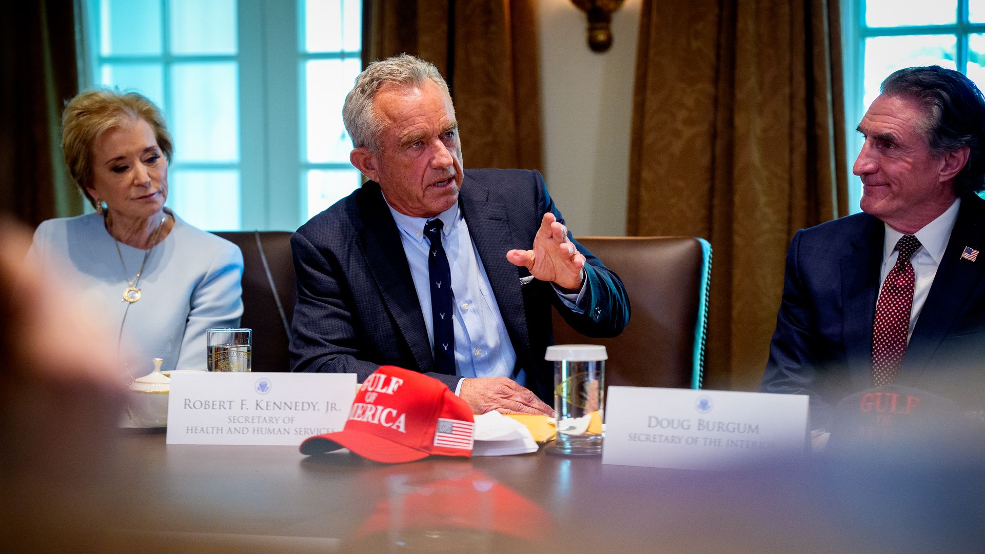 Health and Human Services Secretary Robert F. Kennedy Jr., accompanied by Education Secretary Linda McMahon (L), and Interior Secretary Doug Burgum (R), speaks during a Cabinet meeting at the White House.