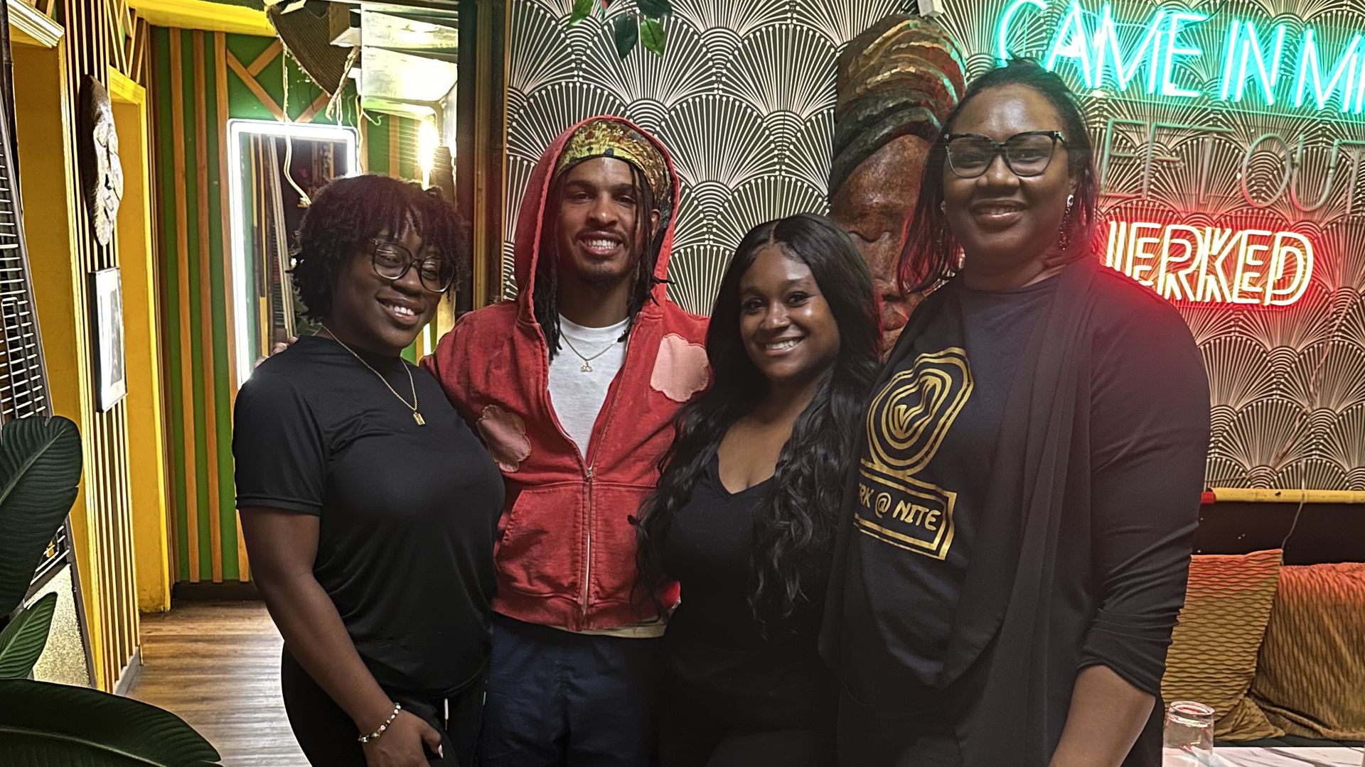 Keith Lee (center, in a red sweatshirt) with staff at Jerk At Nite