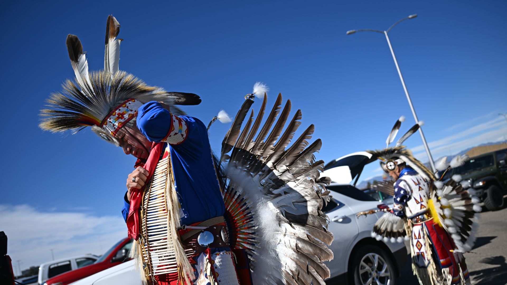  Ramon Bear Runner, left, and Lester Lone HIll, both Oglala Lakota, put on their regalia near their cars before heading inside to take part in the 49th annual Denver March Powwow at the Denver Coliseum in Denver, Colorado on March 23, 2025. 